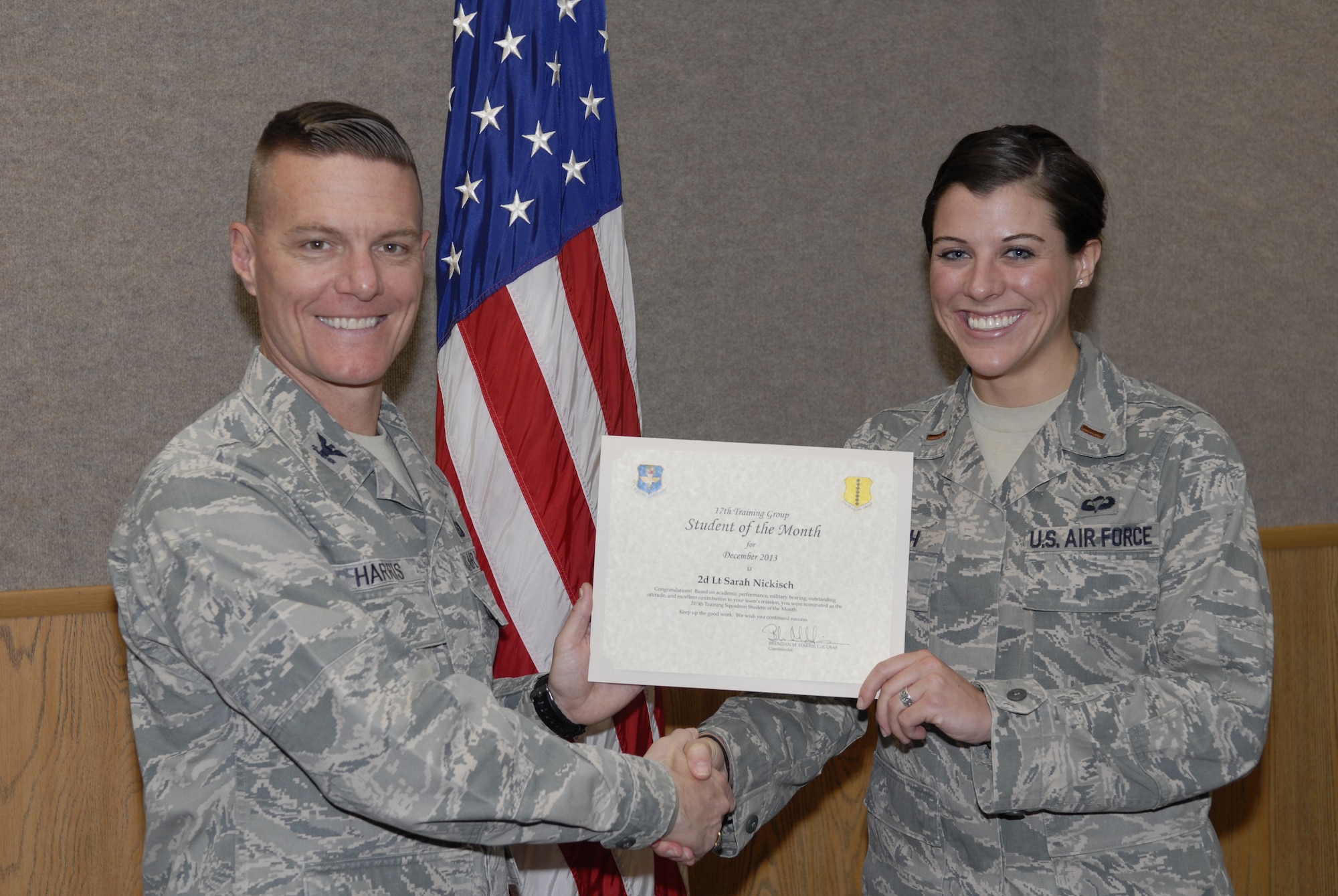 GOODFELLOW AIR FORCE BASE, Texas -- Col. Brendan Harris, 17th Training Group Commander, presents the 315th Training Squadron Officer Student of the Month award for December 2013 to 2nd Lt. Sarah Nickisch Jan. 3. (U.S. Air Force photo/ Lucian Czarnecki)