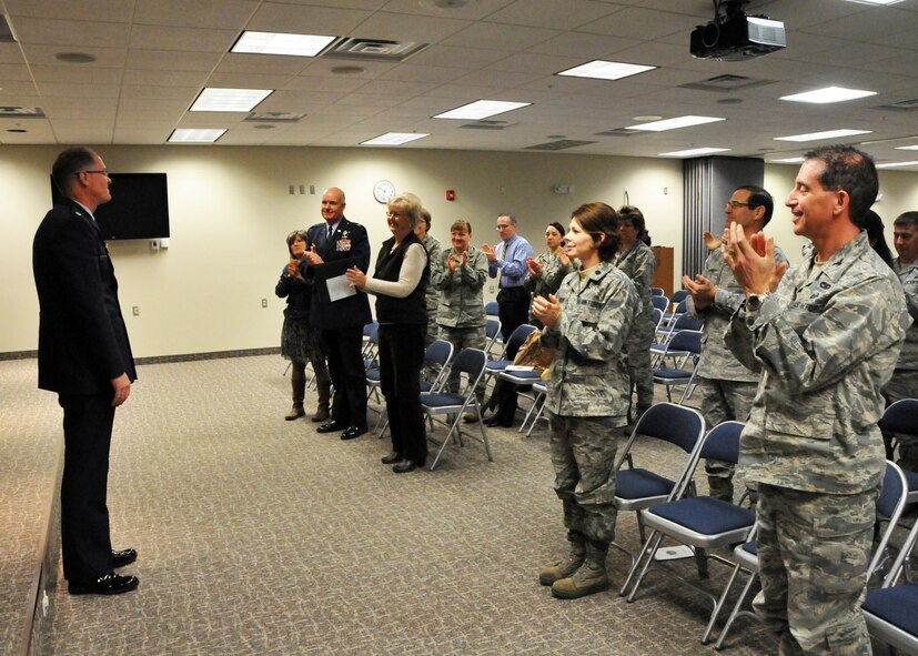 Chaplain (Lt. Col.) John Allen receives a standing ovation at the conclusion of his retirement ceremony held at the 120th Fighter Wing in Great Falls, Mont. on Dec. 8, 2013. National Guard photo/Senior Master Sgt. Eric Peterson.