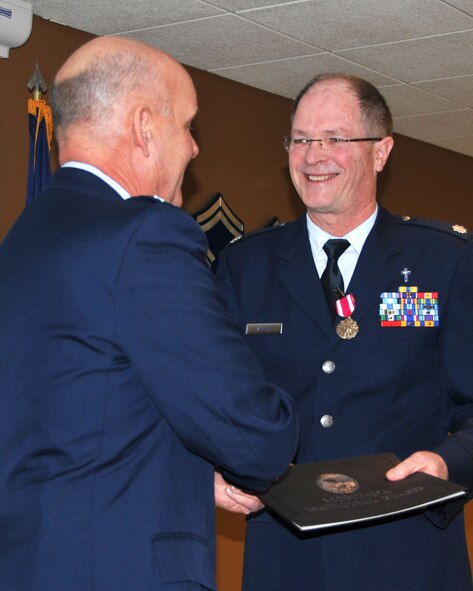 Chaplain (Lt. Col.) John Allen receives his certificate of retirement from the Armed Forces of the United States from 120th Fighter Wing Commander Col. J. Peter Hronek on Dec. 8, 2013 in Great Falls, Mont. National Guard photo/Senior Master Sgt. Eric Peterson.