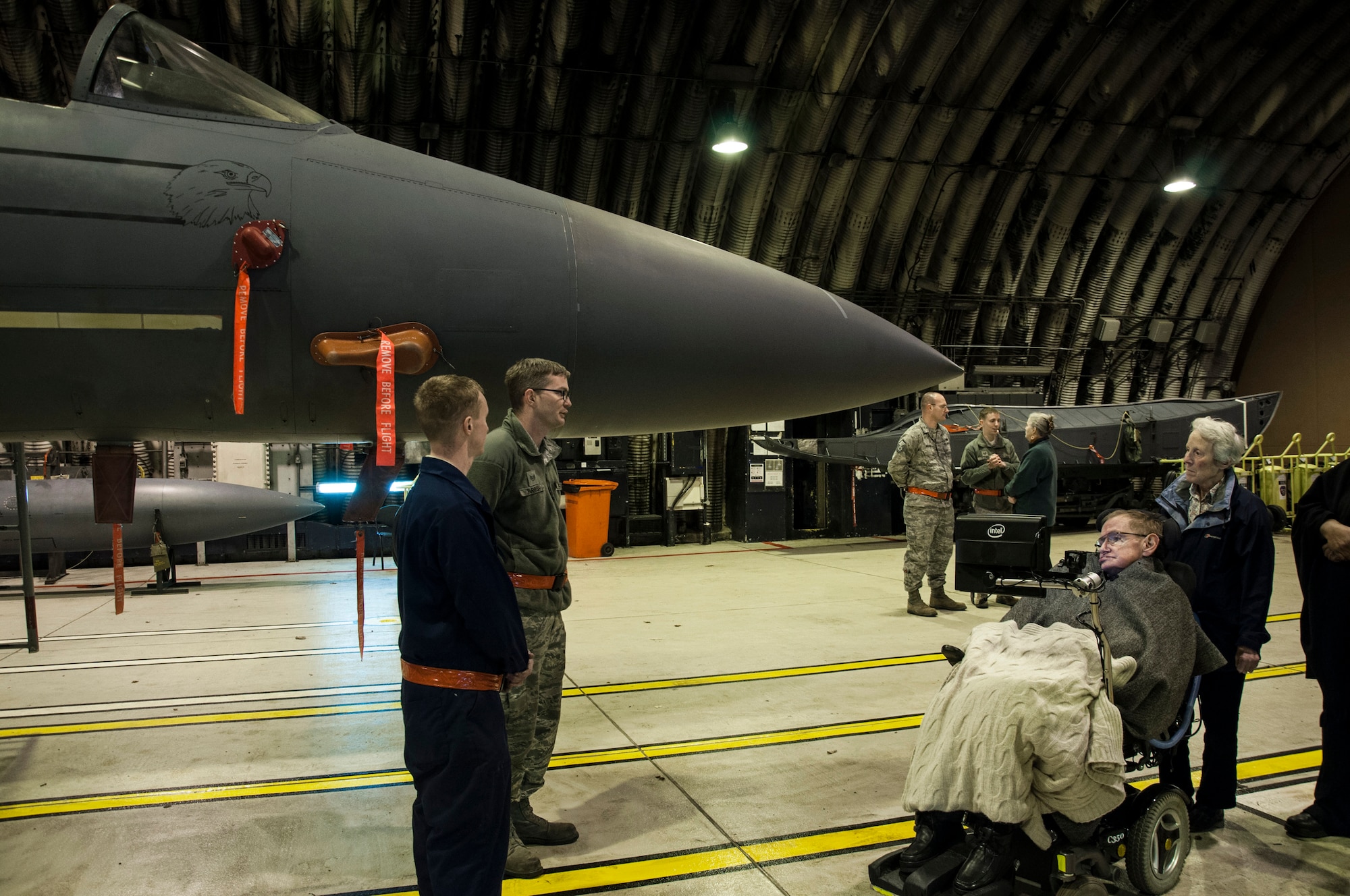 Personnel from the 48th Aircraft Maintenance Squadron discuss the roles and capabilities of the F-15E Strike Eagle with Professor Stephen Hawking, famed scientist and professor at the University of Cambridge, at Royal Air Force Lakenheath, England, Dec. 29, 2013. Hawking had coordinated the visit through his friend, the widow of a retired U.S. Air Force master sergeant.  Master Sgt. Patrick Robison, 48th Aircraft Maintenance Squadron maintenance debrief NCO in charge, said his “maintainers did an exceptional job representing the Liberty Wing and the United States Air Force.” (Courtesy photo by RAF Sqn. Ldr. Jerry Neild)