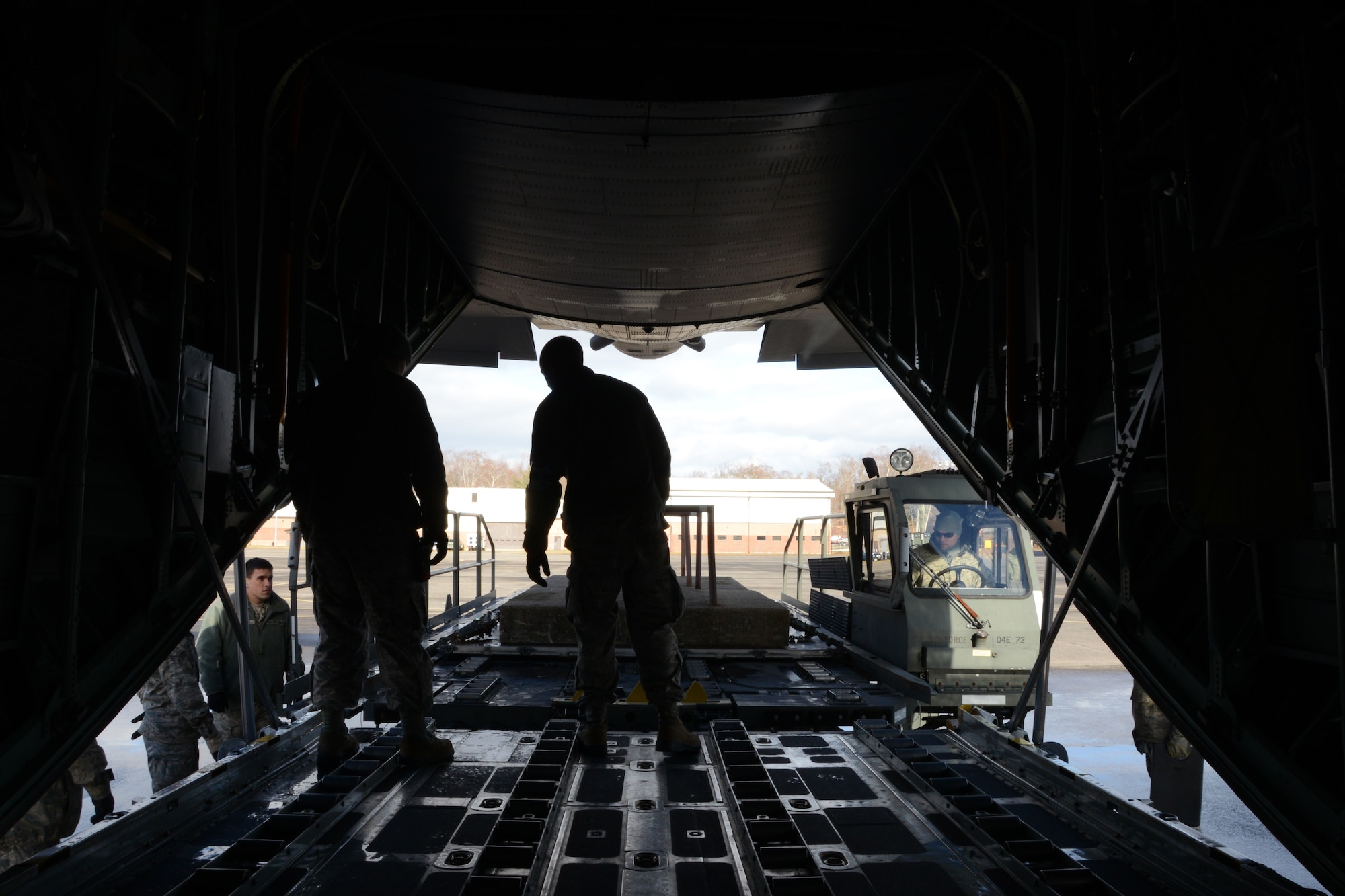 Air transportation craftsmen of the 103rd Logistics Readiness Squadron load an 8,800 pound training rock onto a C-130H on Bradley Air National Guard Base, East Granby, Conn., Dec. 8, 2013. With the arrival of Bradley’s new C-130s, the Airmen take advantage of any opportunity to get hands-on training.  (U.S. Air National Guard photo by Senior Airman Emmanuel Santiago)