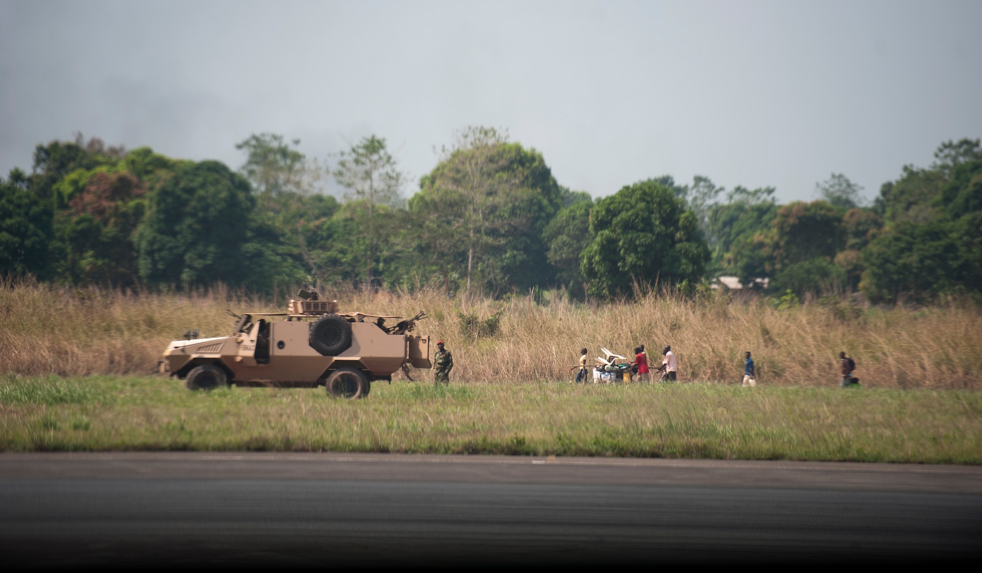 Displaced civilians from Central African Republic, Africa walk along an airfield Dec. 20. Airmen of the 37th Airlift Squadron, assigned to Ramstein Air Base, Germany, along with several allied nations, delivered much-needed supplies and personnel to Central African Republic, Africa, as part of an international peace-keeping mission providing support to the civilian population disrupted by the nation’s recent conflicts. (U.S. Air Force photo/Senior Airman Damon Kasberg)
