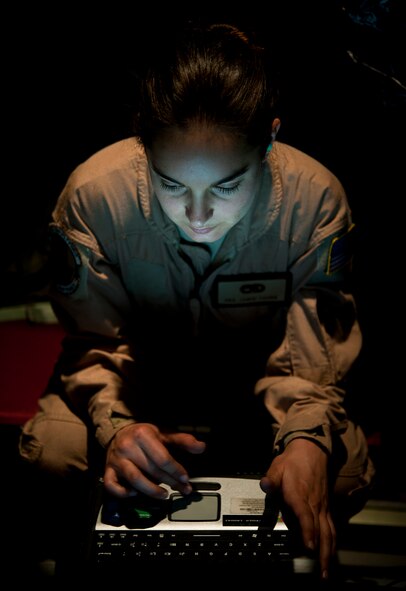 Senior Airman Jamie Young, 86th Aircraft Maintenance Squadron crew chief, looks through the diagnostics of a C-130J to ensure it is working properly Dec. 18 on Sigonella Naval Air Station, Italy. Airmen of the 37th Airlift Squadron, assigned to Ramstein Air Base, Germany, delivered much-needed supplies and personnel to Central African Republic, Africa, in order to help stabilize the region after recent conflicts. (U.S. Air Force photo/Senior Airman Damon Kasberg)