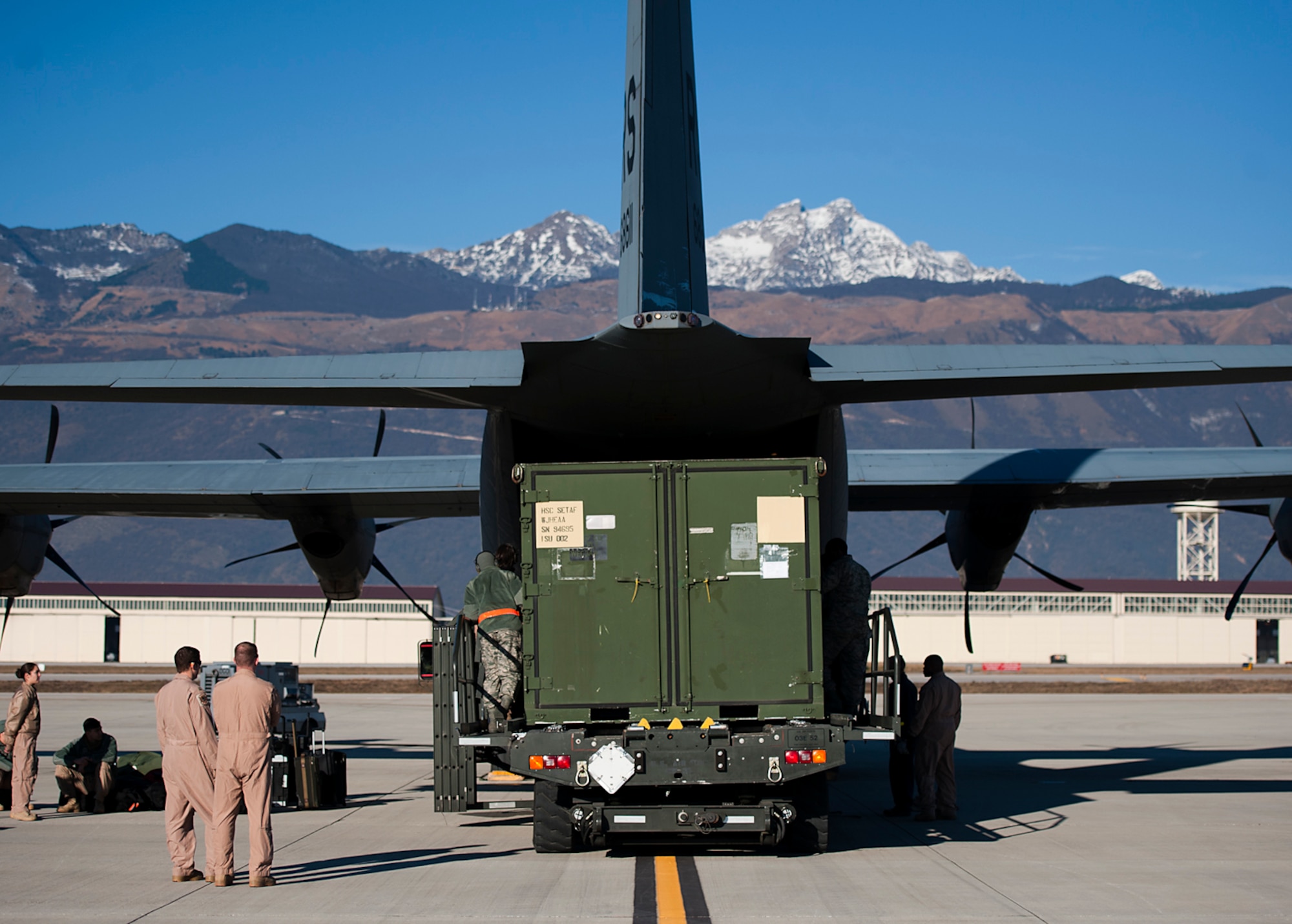Airmen place cargo into a C-130J Super Hercules, Dec. 17 on Aviano Air Base, Italy. Airmen of the 37th Airlift Squadron, assigned to Ramstein Air Base, Germany, along with several allied nations, delivered much-needed supplies and personnel to Central African Republic, Africa. This effort is part of an international peace-keeping mission providing support to the civilian population disrupted by the nation’s recent conflicts. (U.S. Air Force photo/Senior Airman Damon Kasberg)