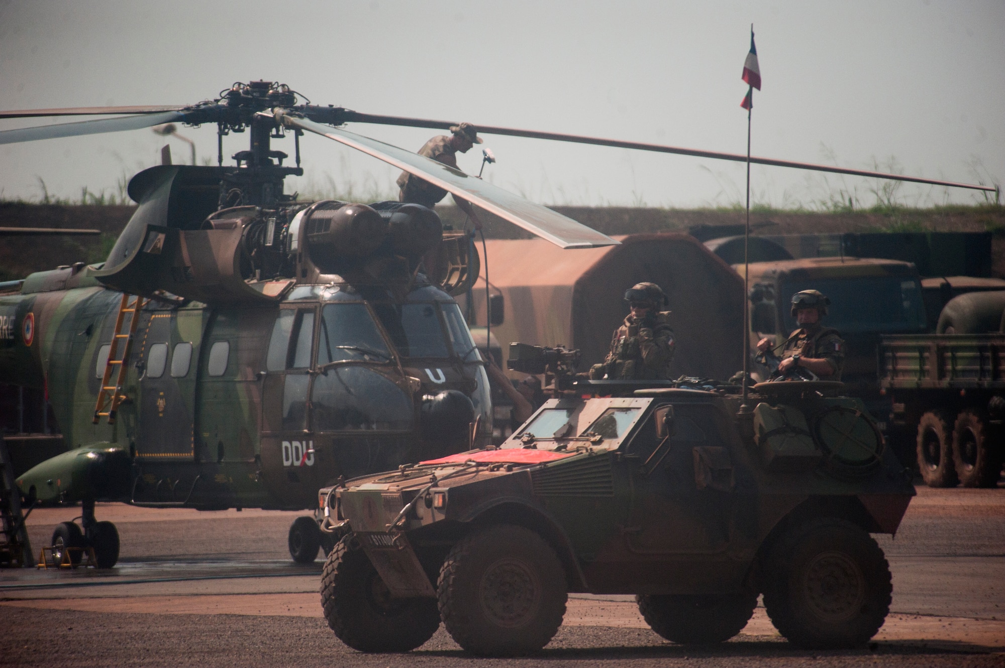Members of the French military patrol an airfield Dec. 20 in the Central African Republic, Africa. Airmen of the 37th Airlift Squadron, assigned to Ramstein Air Base, Germany, worked alongside French military forces on the ground to deliver much-needed supplies and personnel as part of an international peace-keeping mission providing support to the civilian population disrupted by the nation’s recent conflicts. (U.S. Air Force photo/Senior Airman Damon Kasberg)