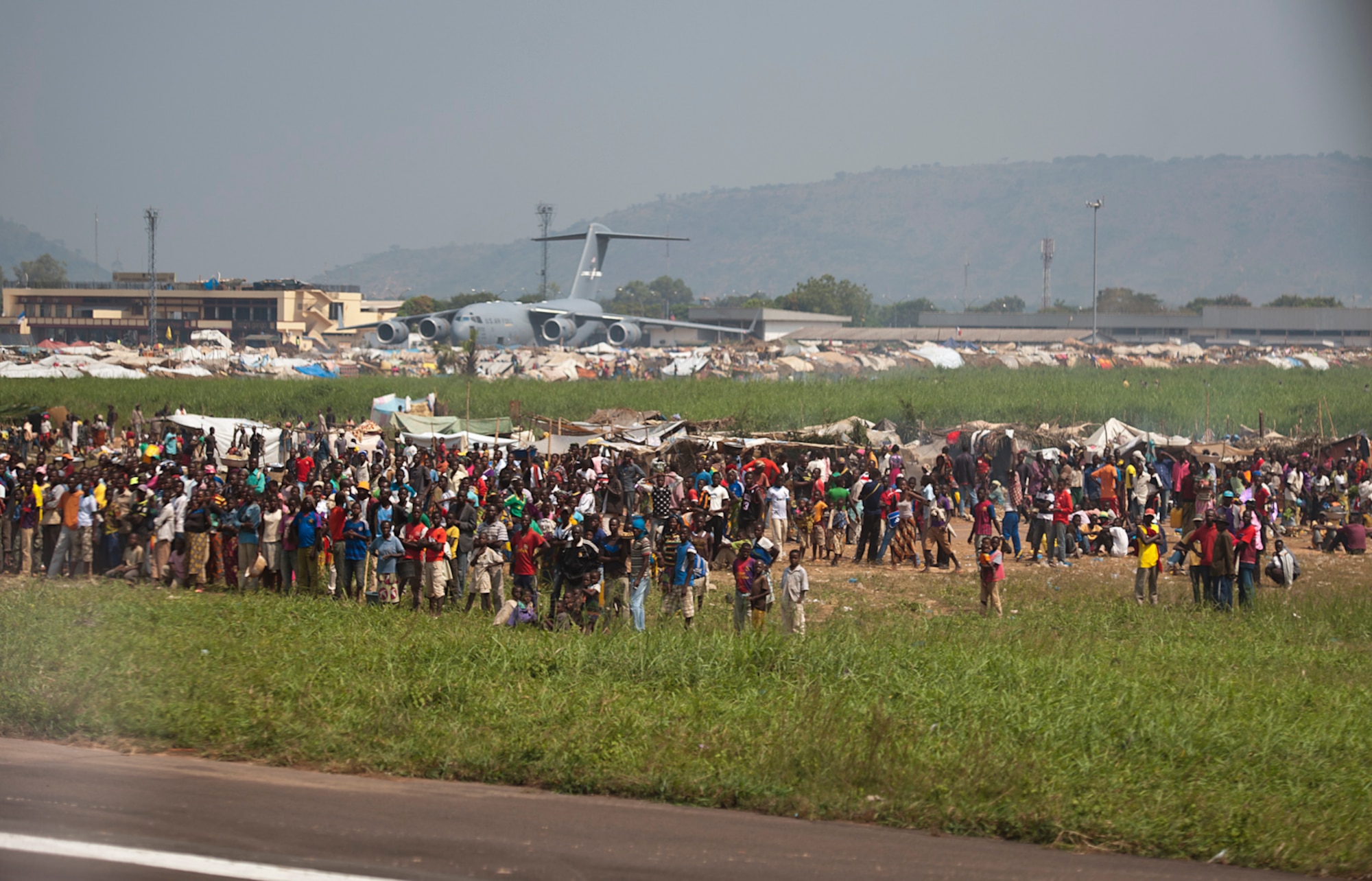 Displaced civilians from Central African Republic, Africa, gather in make-shift living facilities to escape conflict in their home nation Dec. 20, 2013. Airmen of the 37th Airlift Squadron, assigned to Ramstein Air Base, Germany, delivered much-needed supplies and personnel to Central African Republic, Africa, as part of an international peace-keeping mission providing support to the civilian population disrupted by the nation’s recent conflicts. (U.S. Air Force photo/Senior Airman Damon Kasberg)