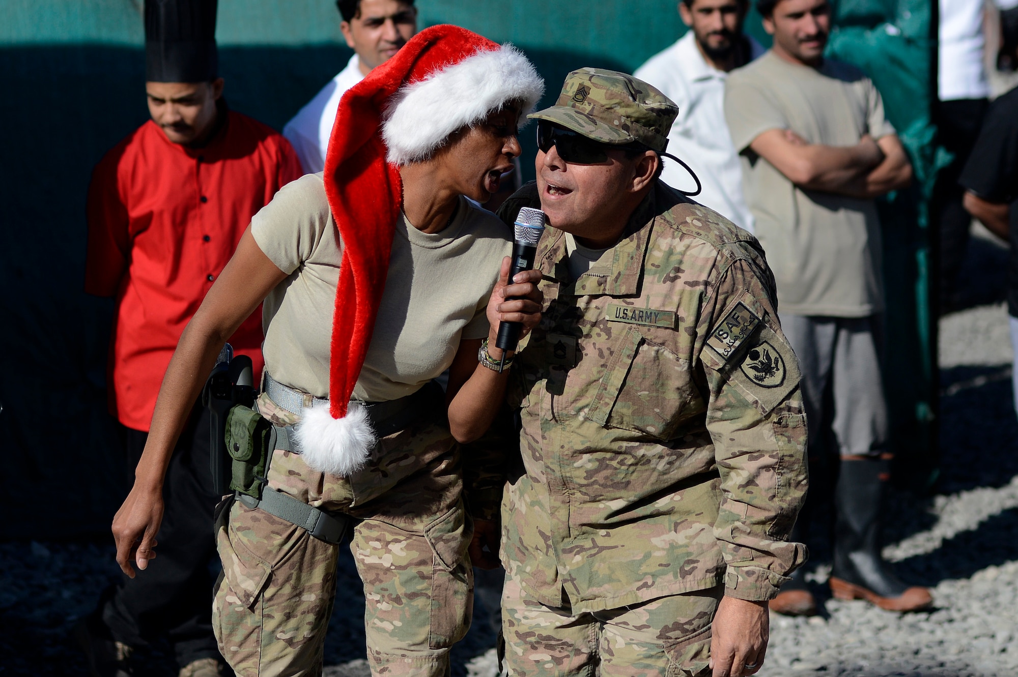 U.S. Air Force Tech. Sgt. Felita LaRock, Air Force Central Command Band vocalist, sings with U.S. Army Sgt. 1st Class Arturo Mercado, 266th Ordnance Battalion, Puerto Rico National Guard during a Christmas celebration Dec. 25, 2013, at Forward Operating Base Fenty, Jalalabad, Afghanistan. The AFCENT band entertained service members during Christmas eve and Christmas day performances while at FOB Fenty, the last stop on their 15 day tour of Afghanistan. (U.S. Air Force photo by Tech. Sgt. Jason Robertson/released)