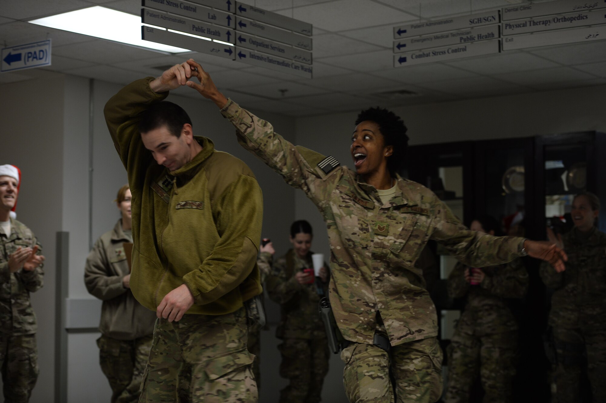 U.S. Air Force Capt. Ben Stone 455th Expeditionary Medical Operations Squadron emergency room doctor, dances with U.S. Air Force Tech. Sgt. Felita LaRock, Air Force Central Command Band vocalist, during a performance at the Craig Joint Theater Hospital, Bagram Air Field, Afghanistan, Dec. 22, 2013. The AFCENT band performed at various locations around Bagram Air Field during their 15 day tour of Afghanistan. (U.S. Air Force photo by Tech. Sgt. Jason Robertson/released)