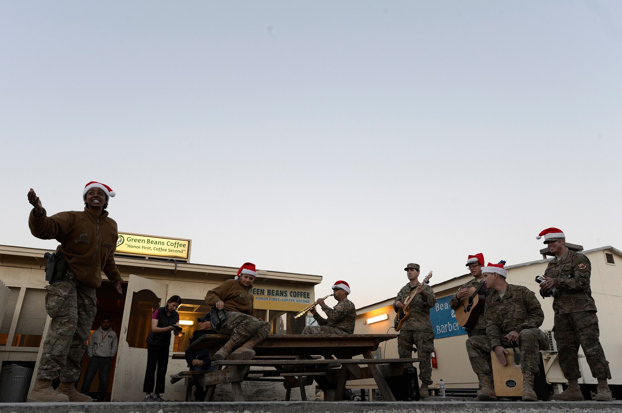 The Air Force Central Command Band performs for service members outside a green beans coffee shop Dec. 24, 2013, at Forward Operating Base Fenty, Jalalabad, Afghanistan. The AFCENT band entertained service members during Christmas eve and Christmas day performances while at FOB Fenty, the last stop on their 15 day tour of Afghanistan. (U.S. Air Force photo by Tech. Sgt. Jason Robertson/released)
