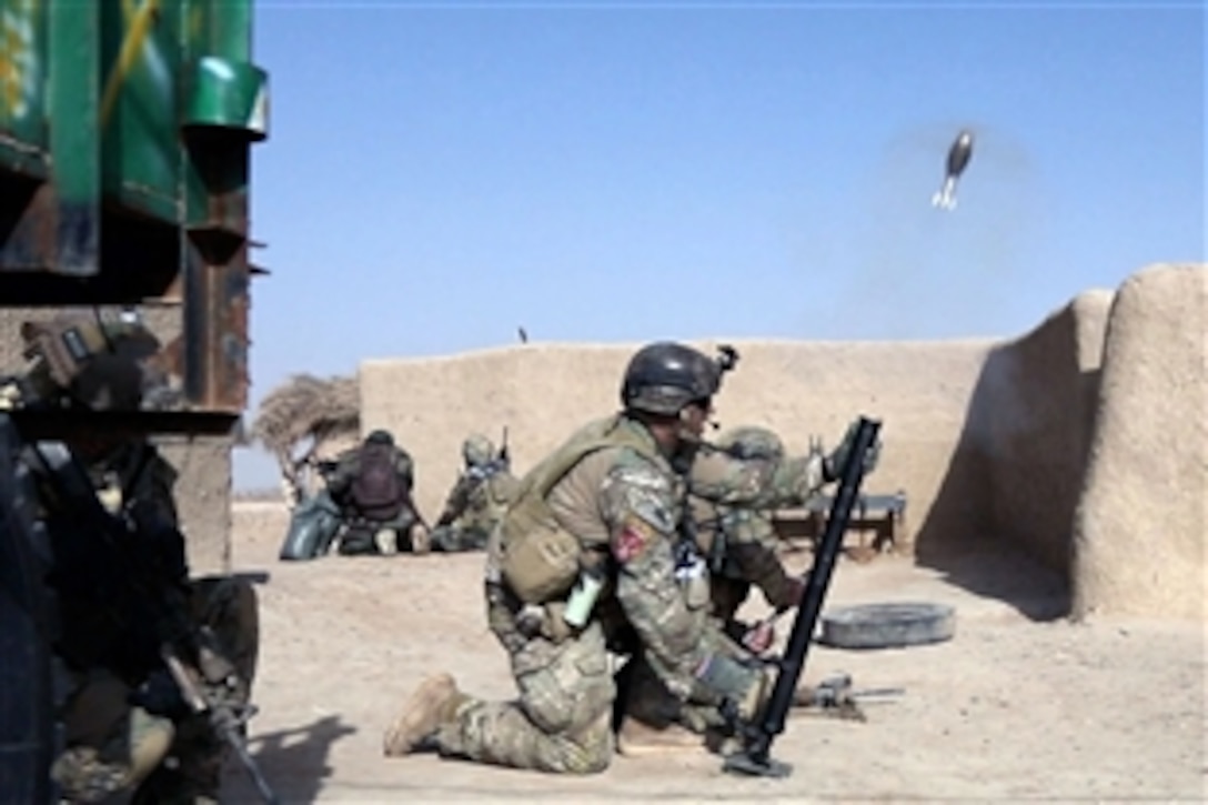 U.S. Special Forces soldiers fire a mortar round toward an identified enemy fighting position while assisting Afghan forces clear Bahlozi village in the Maiwand district of Afghanistan's Kandahar province, Jan. 1, 2014. Forces conducted the clearance mission to disrupt insurgents who hide in the village. The U.S. Special Forces soldiers are assigned to Combined Joint Special Operations Task Force-Afghanistan. 