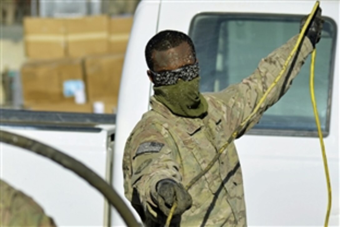 U.S. Air Force Senior Airman Andrew Wright assists with pouring the concrete foundation for a new maintenance facility on Kandahar Airfield, Afghanistan, Jan. 4, 2014. Wright is an electrician assigned to the 577th Expeditionary Prime Base Engineer Emergency Force Squadron, known as Prime Beef. 

