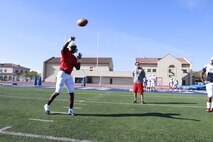 Quentin Gibson, quarterback for the Semper Fidelis All-American Bowl East Team throws a football to his teammate, Jan. 2, 2014. The Semper Fidelis All-American Bowl will be held on Jan. 5, 2014, at 6 p.m. PST in Carson, Calif., at The StubHub Center and aired live on Fox Sports 1. (Official U.S. Marine Corps photo by Sgt. Andres J. Lugo/Released)