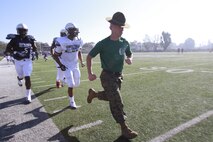 Gunnery Sgt. Michael Wampler, a drill instructor at Marine Corps Recruit Depot in San Diego, Calif. runs with players from the Semper Fidelis All-American Bowl East Team, Jan. 2, 2014. The Semper Fidelis All-American Bowl will be held on Jan. 5, 2014, at 6 p.m. PST in Carson, Calif., at The StubHub Center and aired live on Fox Sports 1. (Official U.S. Marine Corps photo by Sgt. Andres J. Lugo/Released)