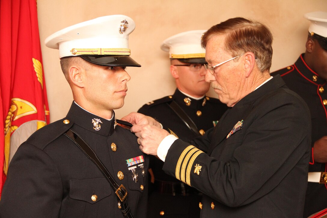 2nd Lt. Robin Shuberg is pinned by his father, retired Cmdr. Richard Shuberg, during a commissioning ceremony, Jan 3. Shuberg, a Chippewa Lake, Mich. native, served as an enlisted Marine before leaving the service to pursue a bachelor’s degree in Recreational Leadership Management through Ferris State University. While earning his degree, Shuberg participated in the Platoon Leaders Class (PLC) to earn his commission. For more information on the PLC Program visit Marines.com