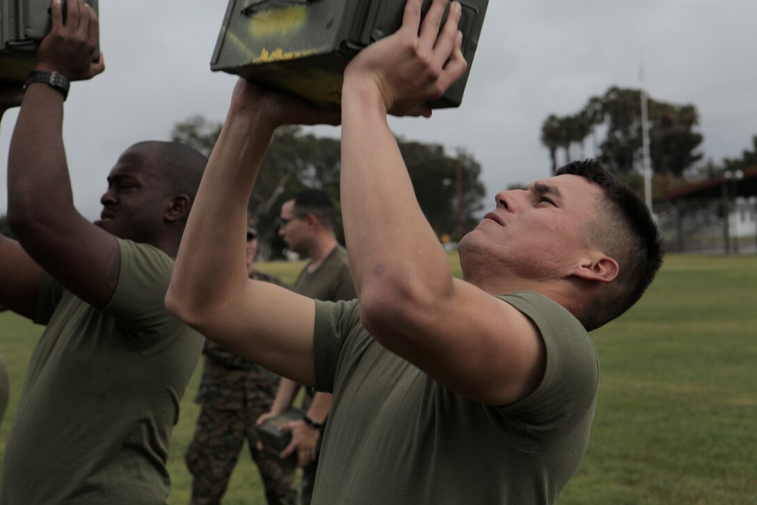 Lance Cpl. Wesley Ward, a military police officer with 1st Law Enforcement Battalion, from Anaheim, Calif., executes the ammo can lift portion of the Combat Fitness Test at Paige Field House in Camp Pendleton, Calif., Dec. 19. The CFT is an annual requirement for all Marines that builds unit cohesion and ensures combat readiness.