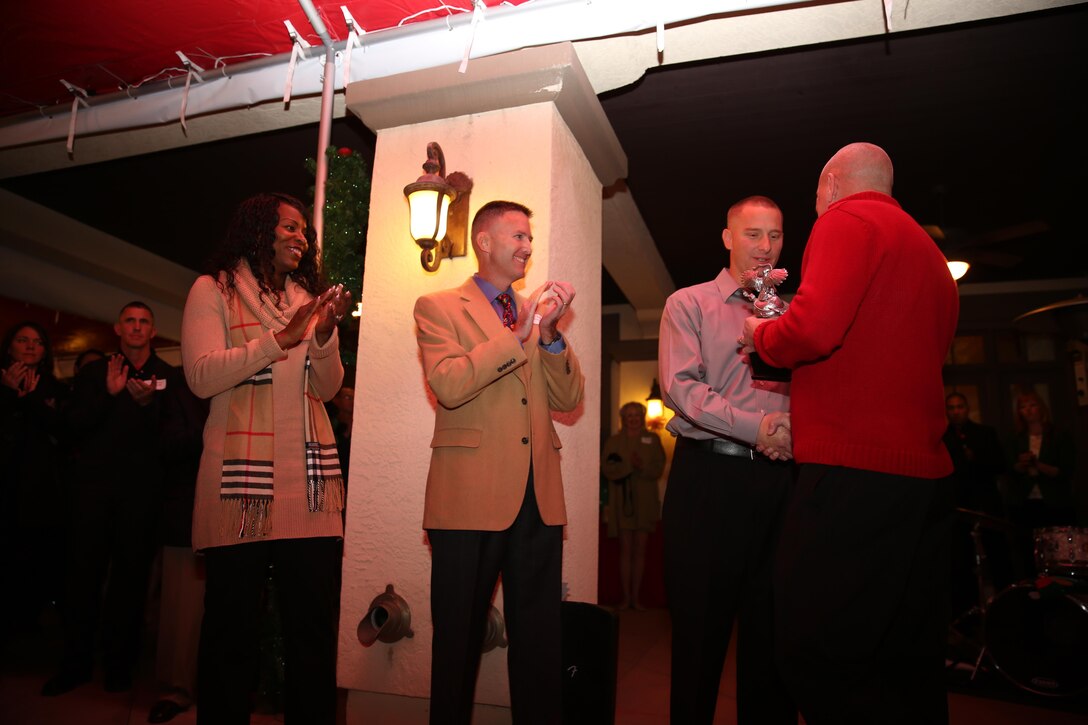 Sergeant Michael Burgess receives the Cpl. Mario Arias Award naming him the first Committed and Engaged Leader of the Year aboard Marine Corps Air Station Miramar, Calif., Dec. 6. Lieutenant Colonel Robert Morgan, center left, former commanding officer of Marine Light Attack Training Squadron (HMLAT) 303, and Sgt. Maj. Donna Dunbar, left, sergeant major of HMLAT-303, attended to commend their successful Marine.


