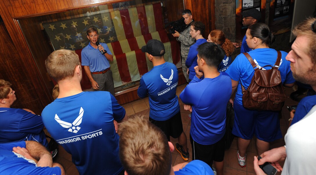 Don Fenton, Pacific Air Forces deputy command historian, gives a tour of the Courtyard of Heroes to Air Force Wounded Warriors at the PACAF headquarters building, Joint Base Pearl Harbor-Hickam, Hawaii, Jan. 6, 2014. The goal of the Air Force Wounded Warrior Adaptive Sports program is to introduce adaptive sports early on in the healing process in order to promote physical, social, emotional and spiritual healing. (U.S. Air Force photo/Master Sgt. Jerome S. Tayborn)