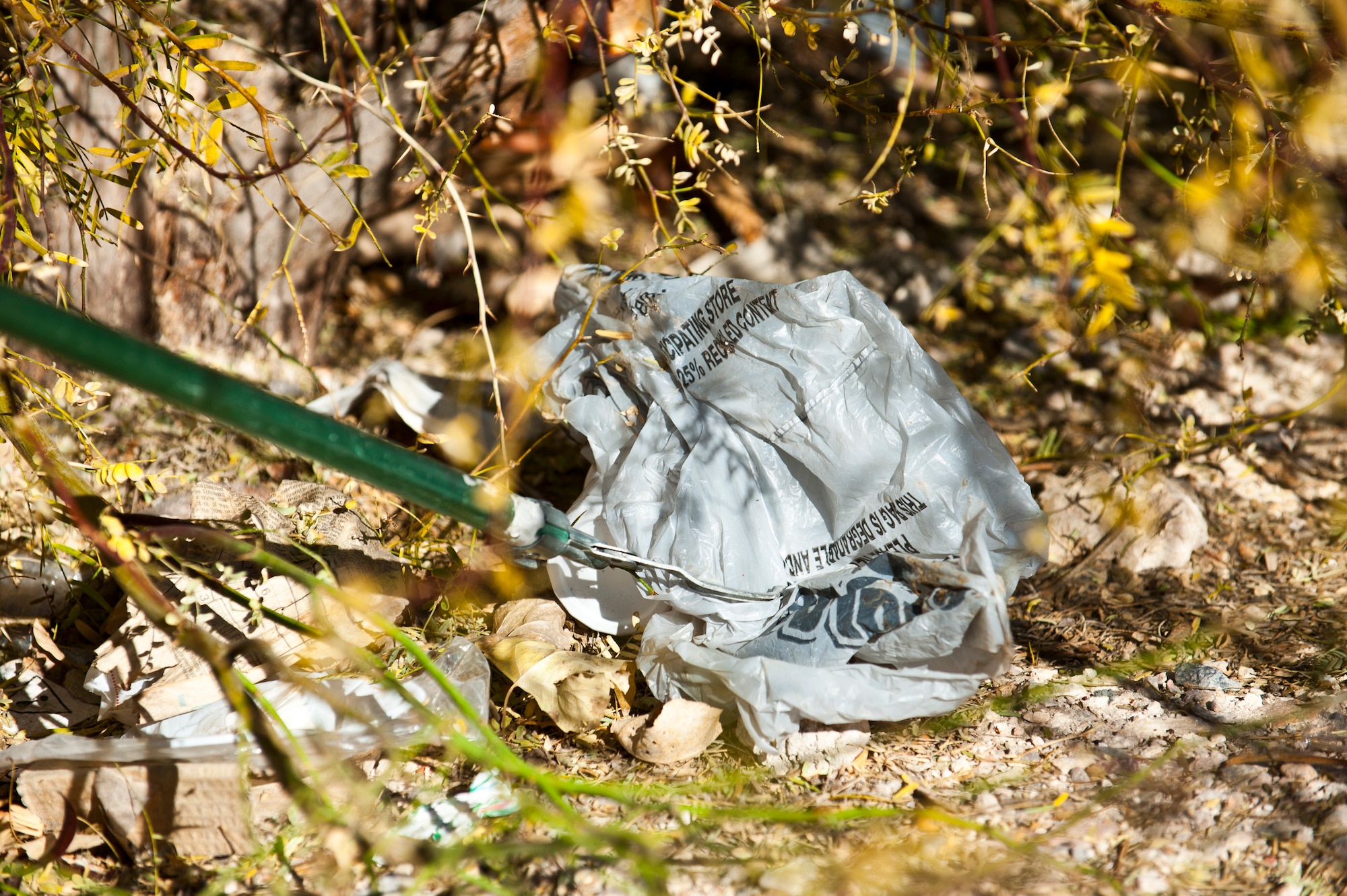 Senior Airman Maximiliano Rodriguez, 99th Civil Engineer Squadron operations manager, picks up trash during a pride patrol Jan. 6, 2014, at Nellis Air Force Base. Nev. The pride patrol’s area of responsibility encompasses almost the entire installation with the exception of the airfield and base housing. (U.S. Air Force photo/Senior Airman Brett Clashman)