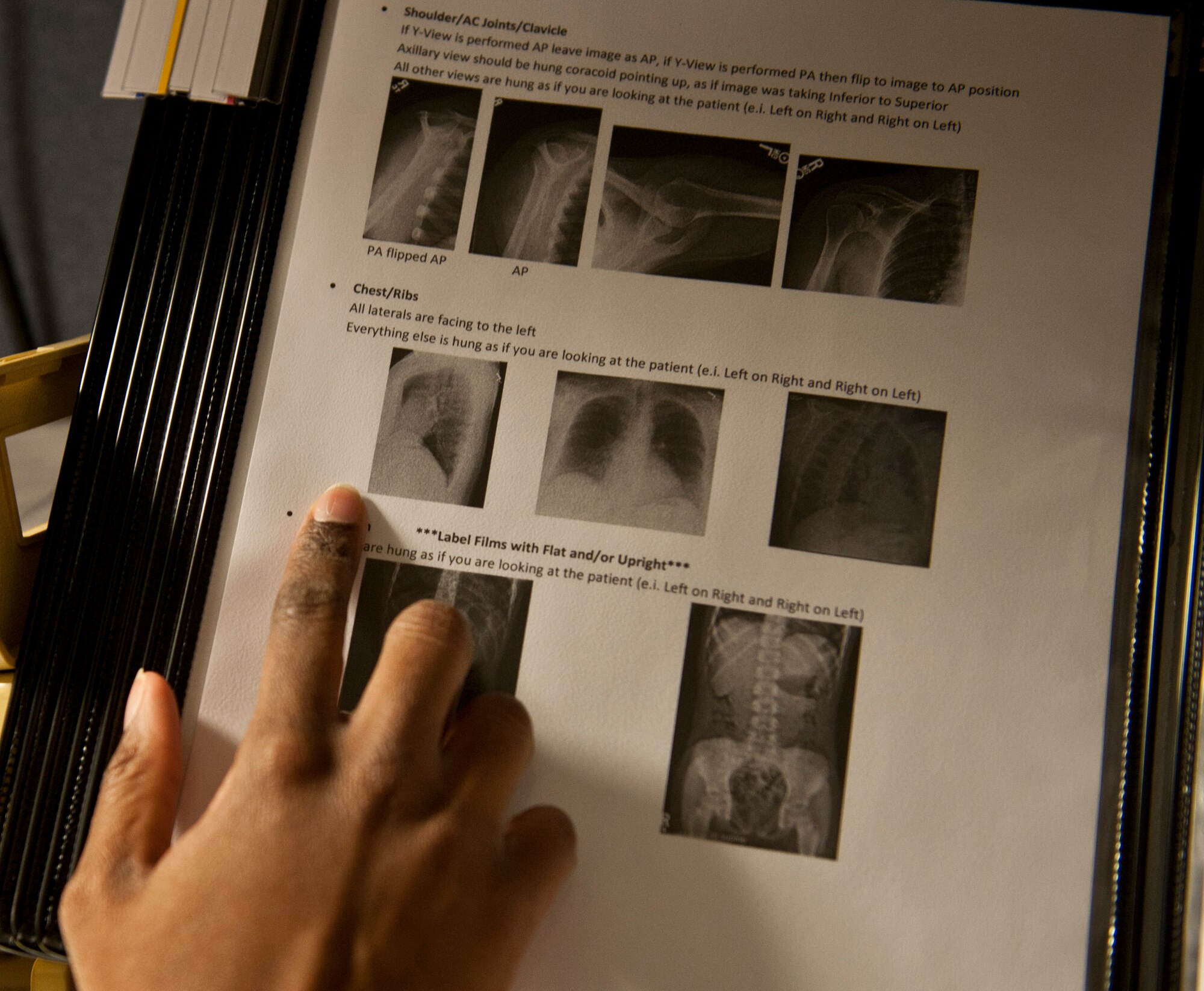 Airman 1st Class Yavonda Brown, 1st Special Operations Medical Support Squadron radiology technician, examines x-ray examples at the 1st Special Operations Medical Group on Hurlburt Field, Fla., Jan. 7, 2014. The radiology section is part of the diagnostics and therapeutics flight. (U.S. Air Force photo/Senior Airman Krystal M. Garrett)