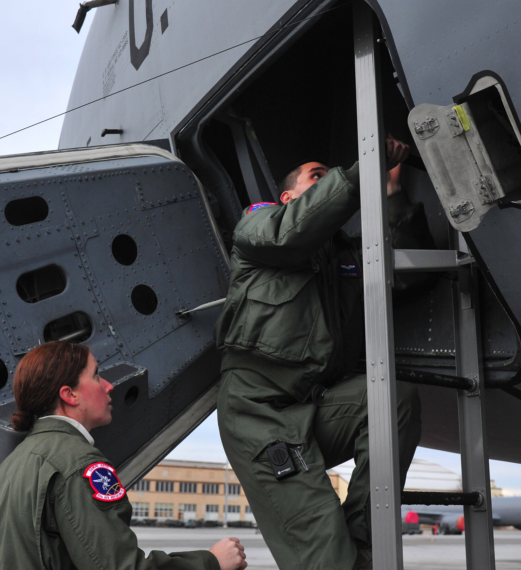 Members of the 93rd Air Refueling Wing climp into a KC-135 Stratotanker during a training scenario on the flightline at Fairchild Air Force Base, Wash., Dec. 17, 2013. The training is to prepare KC-135 crews on short notice response situations. (U.S. Air Force photo by Airman 1st Class Ryan Zeski/Released)
