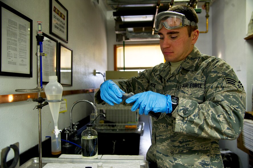 Senior Airman Cole Peck, 5th Logistics Readiness Squadron fuels laboratory technician tests a sample of JP-8 jet fuel at Minot Air Force Base, N.D., Dec. 10, 2013. The base fuels laboratory is responsible for the quality assurance and surveillance and testing of all petroleum products outlined by Department of Defense standards.  (U.S. Air force photo/Senior Airman Brittany Y. Auld)