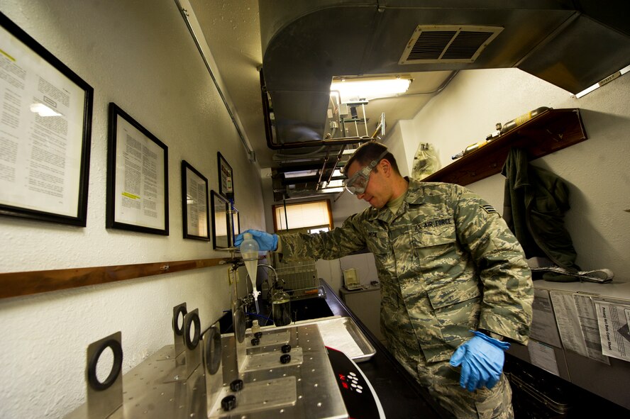 Senior Airman Cole Peck, 5th Logistics Readiness Squadron fuels laboratory technician, conducts fuels testing for dryness, cleanliness and suitability for use at Minot Air Force Base, N.D., Dec. 10, 2013. The primary goal of the fuels laboratory is to make sure the fuel is a clean, quality product that meets all specifications, from the moment it arrives, to the moment it is loaded on an aircraft. (U.S. Air force photo/Senior Airman Brittany Y. Auld)