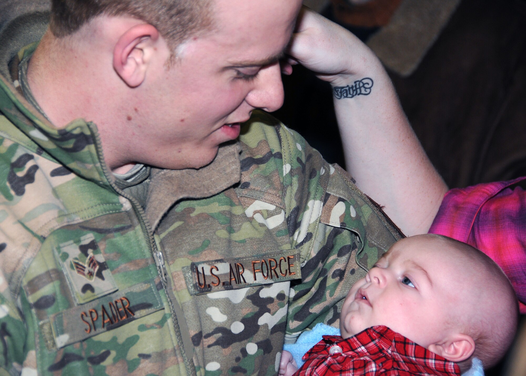 Airman First Class Dalton Spader meets his son Gavin for the first time upon return from a deployment to Kuwait. Gavin was born while Airman Spader was deployed. Airmen from the 143d Airlift Wing Operations Group, Maintenance Group and Logistics Readiness Squadron were deployed in support of Operation Enduring Freedom. National Guard Photo by Master Sgt John McDonald (RELEASED)