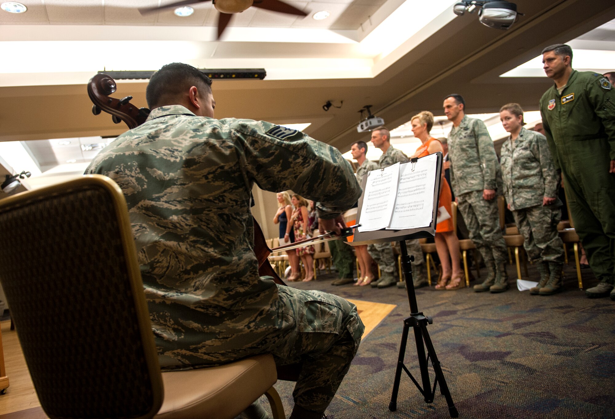 U.S. Air Force Staff Sgt. Joey Lee, 23d Aerospace Medicine Squadron public health technician, plays the national anthem on his cello during an assumption of command at Moody Air Force Base, Ga., Sept. 6, 2013. Lee originally planned to only play at home and church but now plays the national anthem for many base events. (U.S. Air Force photo by Senior Airman Jarrod Grammel/Released)
