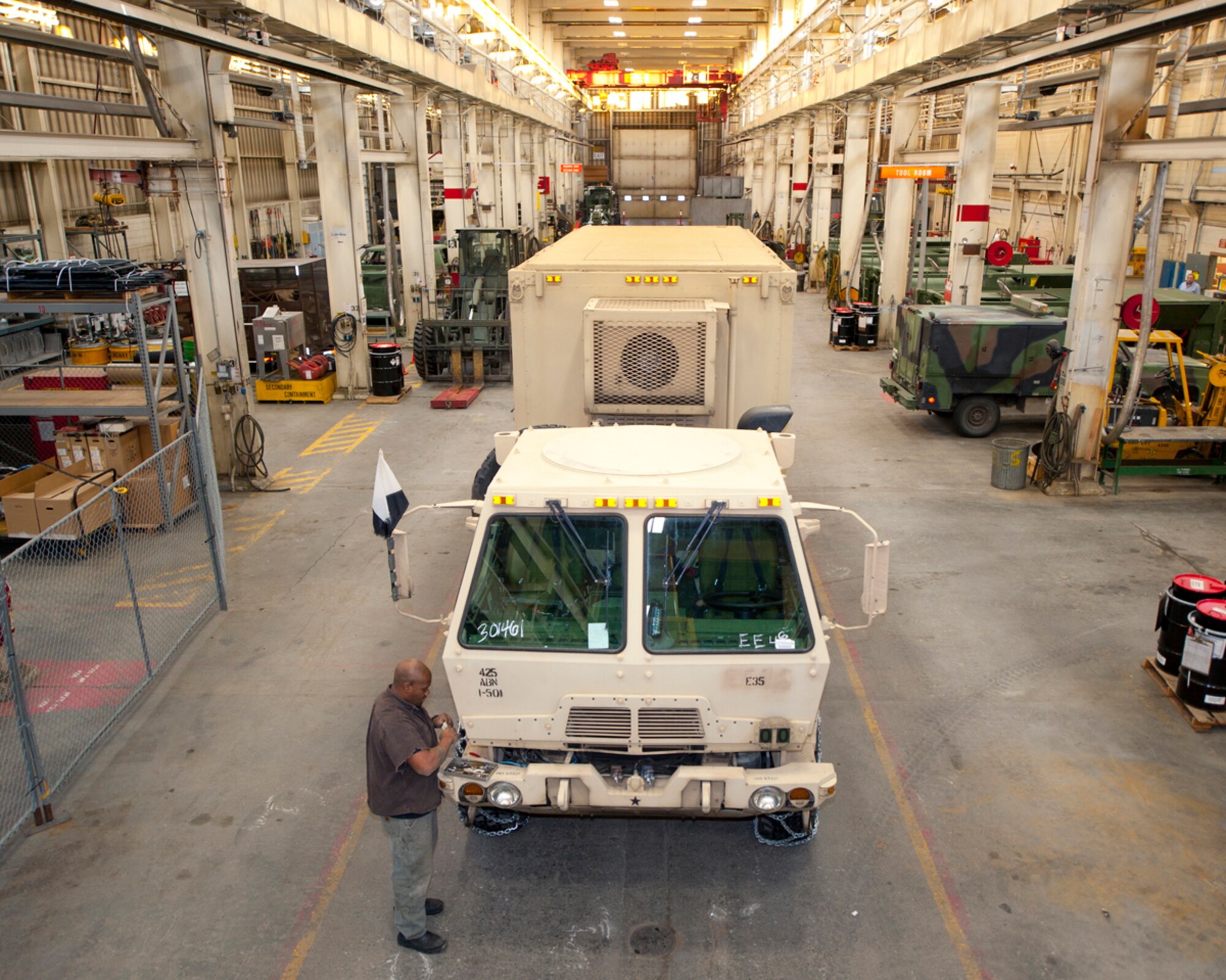 Alvin Payton installs a three-way battery charger to winterize an M-10 87A1 armored mobile truck at the Special Purpose Equipment Repair shop at Joint Base Elmendorf-Richardson, Alaska, Dec. 23. Payton is a heavy mobile equipment mechanic, and is a native of Anchorage, Alaska. (U.S. Air Force photo/Staff Sgt. Robert Barnett)