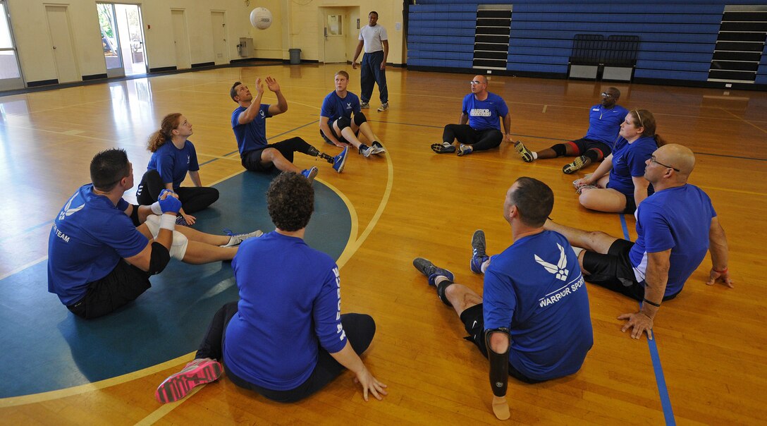 Air Force wounded warriors practice seated volleyball techniques during an Air Force Adaptive Sports Program camp at the Joint Base Pearl Harbor-Hickam Fitness Center, Jan. 6, 2014. The Air Force Wounded Warrior goal program is to return Airmen to duty, but, when that’s not possible, the program works collaboratively with federal agencies and local organizations to ensure a service member’s successful reintegration back into the community. (U.S. Air Force photo/Master Sgt. Jerome S. Tayborn)