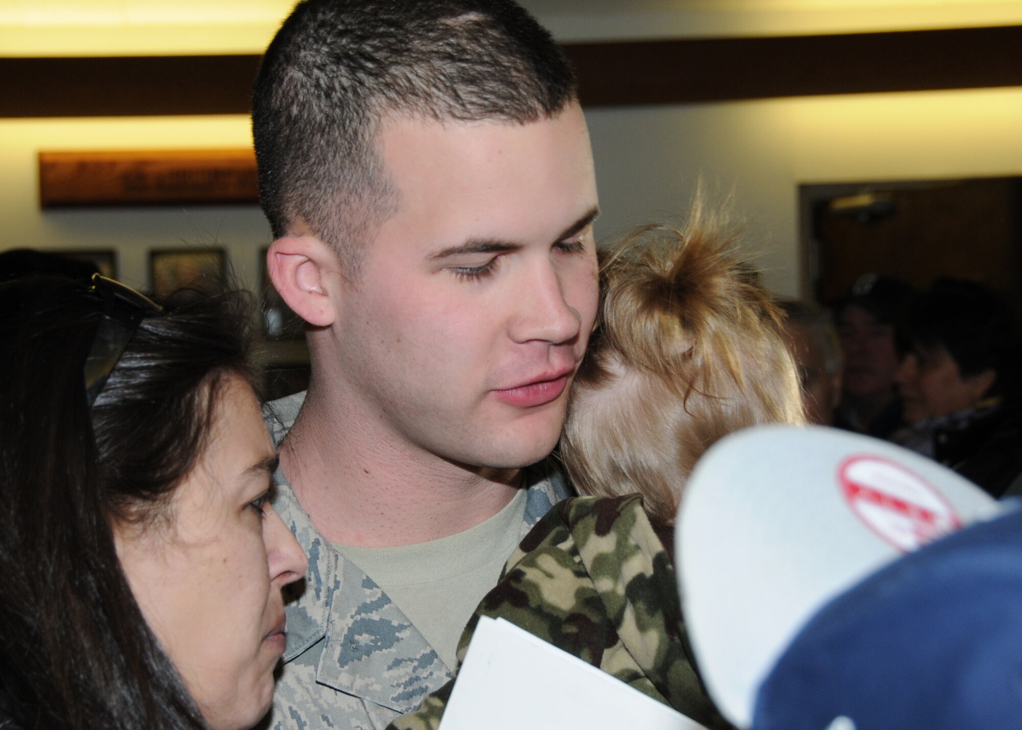 Excited families and friends greet their loved ones upon return from a deployment to Kuwait. Airmen from the 143d Airlift Wing Operations Group, Maintenance Group and Logistics Readiness Squadron were deployed in support of Operation Enduring Freedom. National Guard Photo by Master Sgt John McDonald (RELEASED)