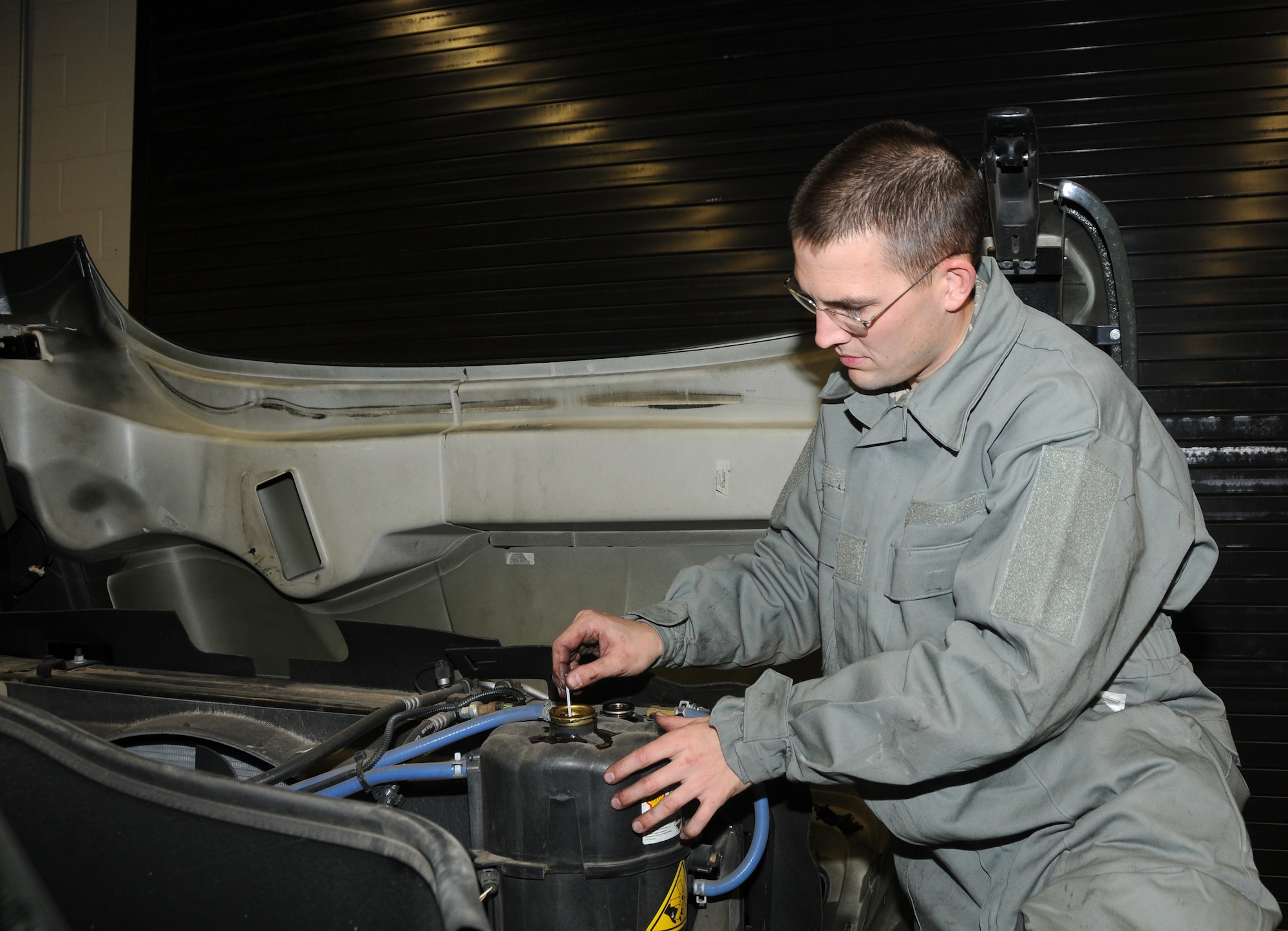 Airman 1st Class Mike Rockford of the 188th Logistics Readiness Squadron changes an air cleaner on an R-11 fueler. Rockford was selected as the 188th Fighter Wing’s Flying Razorback Spotlight for the month of January 2014. (U.S. Air National Guard photo by Senior Airman John Hillier/188th Fighter Wing Public Affairs)
