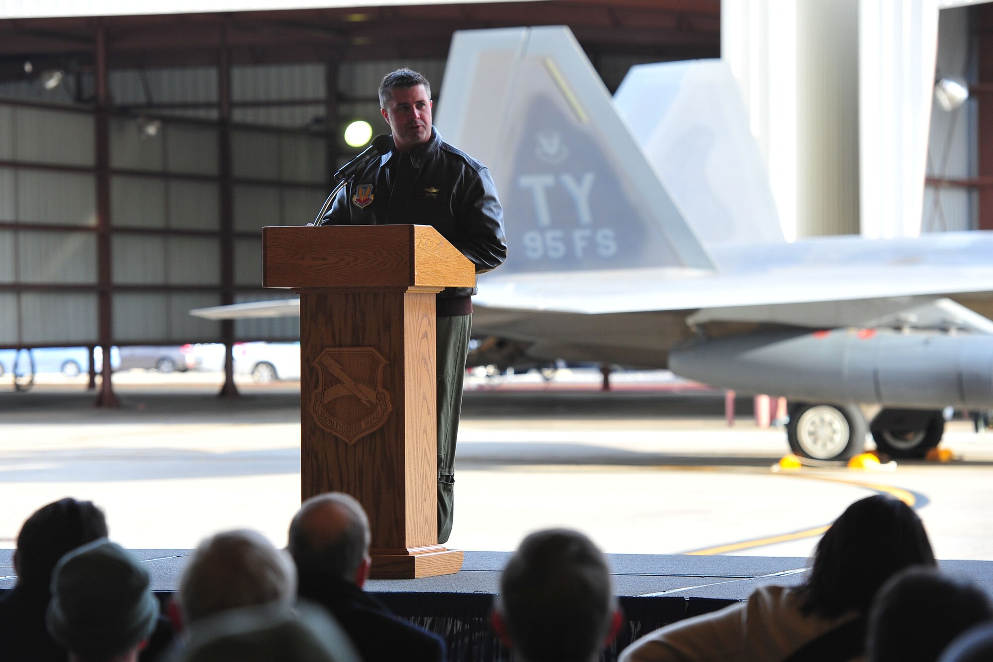 Col. David Graff, 325th Fighter Wing Commander, speaks to a guest audience during the arrival ceremony for five new F-22 Raptors Jan. 6. These jets mark the beginning of a new mission at Tyndall and are the first five of 24 marked to call Tyndall their new home. (U.S. Air Force photo by Airman 1st Class Dustin Mullen)