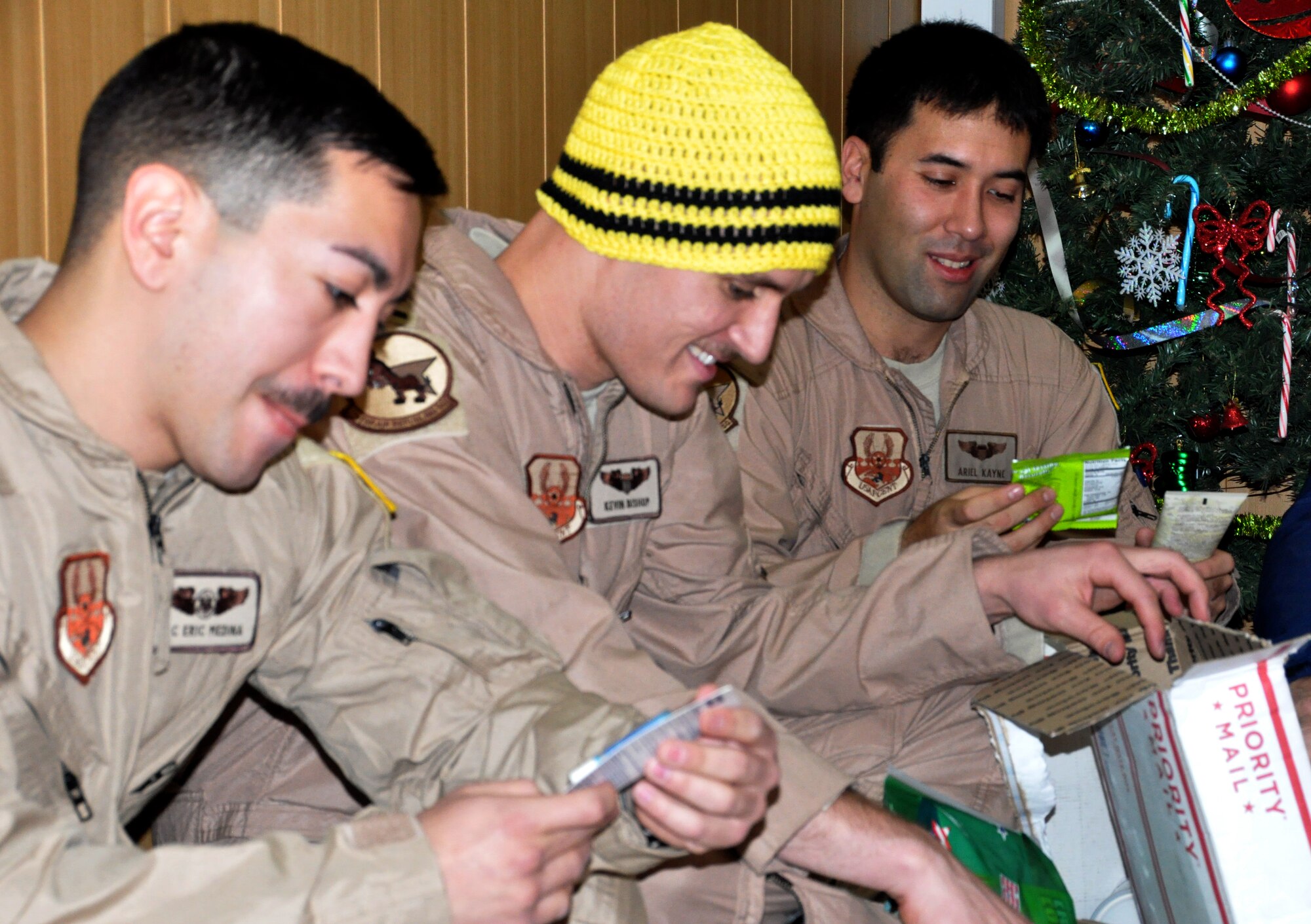 Airmen from the 376th Air Expeditionary Wing at the Transit Center at Manas, Kyrgyzstan open Treats-2-Troops care packages gathered and donated by local community members in Spokane. (U.S. Air Force photo by 2nd Lt. Rachelle Smith/Released)