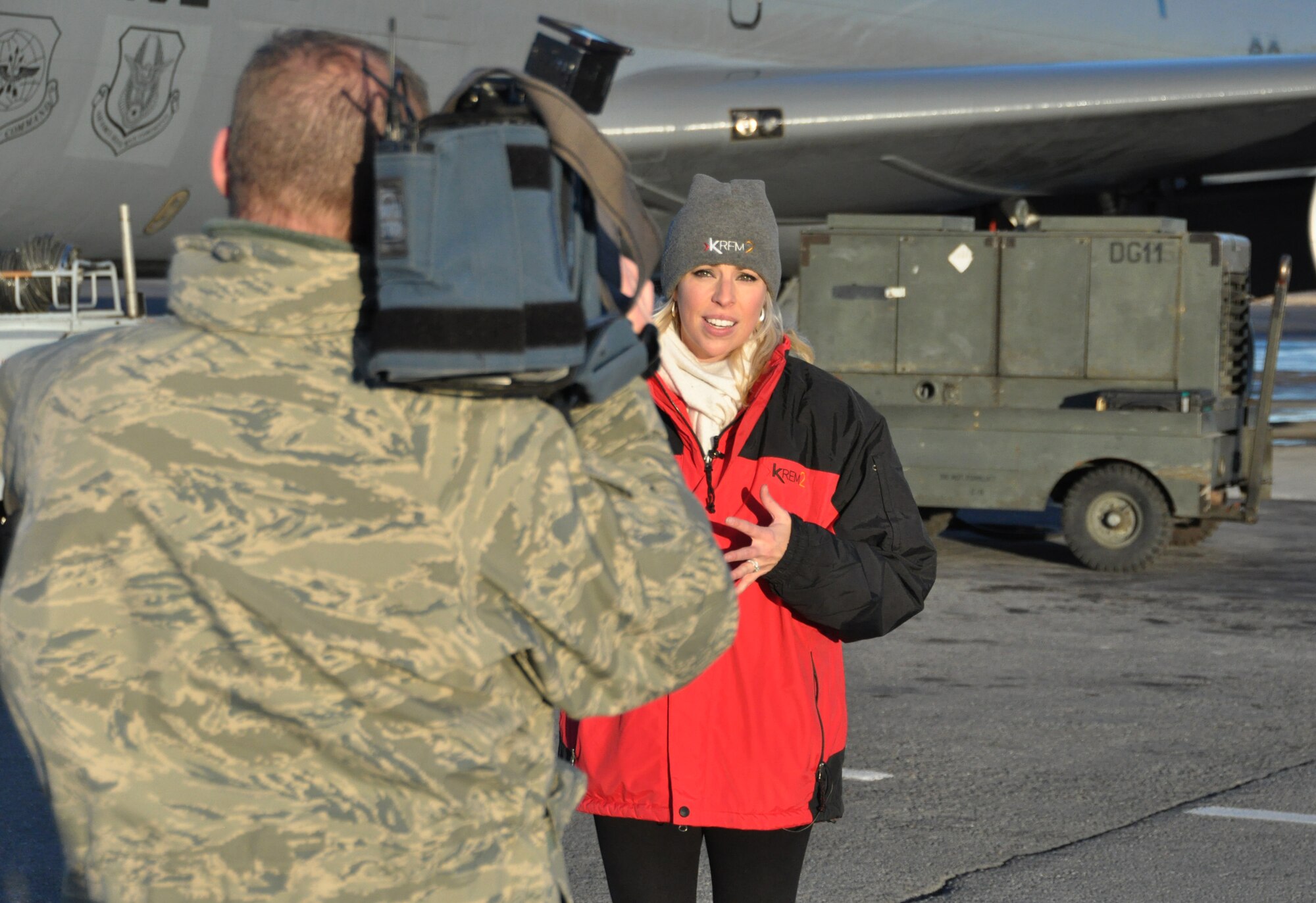 Whitney Ward of KREM 2 News is assisted with a broadcast by Tech. Sgt. Brian Bender, 92nd Air Refueling Wing Public Affairs broadcaster, at the Transit Center at Manas, Kyrgyzstan. Ward was on the ground for three days to interview Airmen from Fairchild Air Force Base, Wash. and deliver Treats-2-Troops. (U.S. Air Force photo by 2nd Lt. Rachelle Smith/Released)