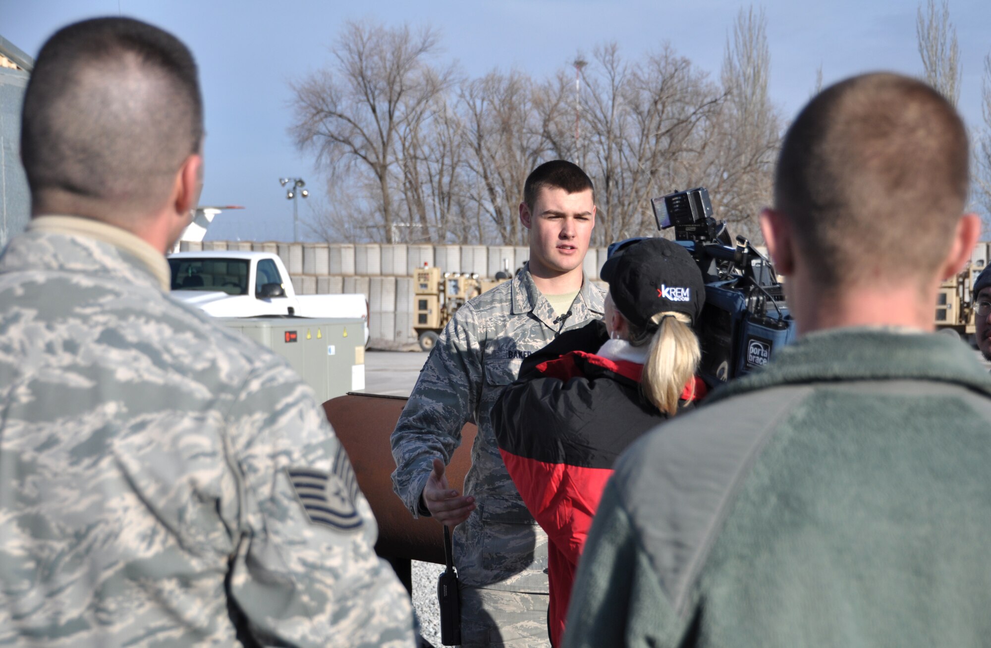 Airman 1st Class Garrett Baker of the 376th Logistics Readiness Squadron does an on-camera interview with Whitney Ward from KREM 2 News explaining his part in the mission at the Transit Center at Manas, Kyrgyzstan. (U.S. Air Force photo by 2nd Lt. Rachelle Smith/Released)