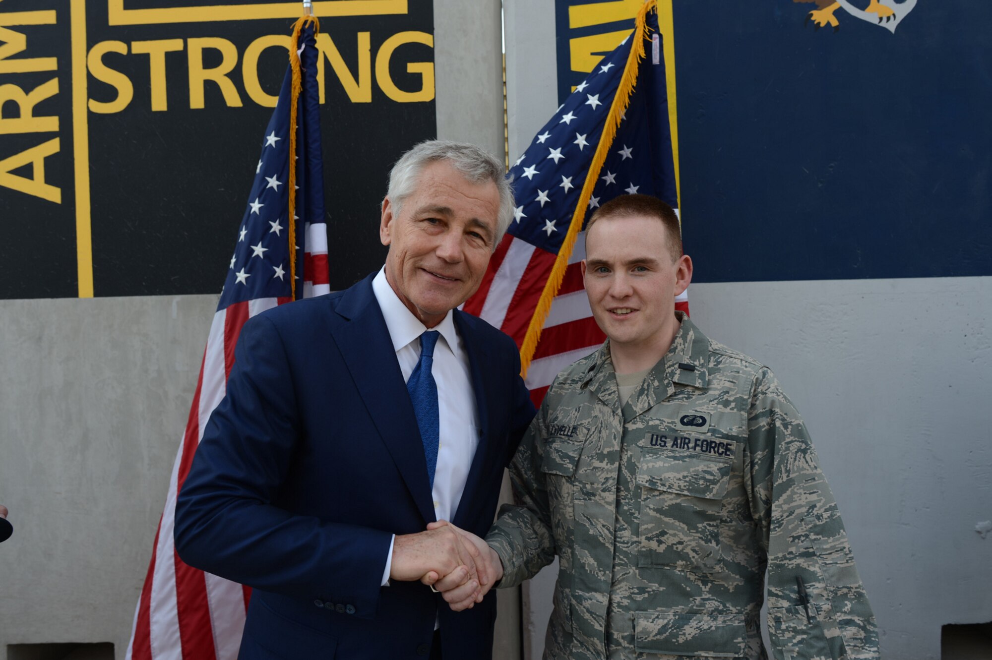 U.S. Air Force 1st Lt. Alex LaVelle, 20th Contracting Squadron contracting officer, shakes hands with the honorable Chuck Hagel, United States Secretary of Defense, after being coined by the secretary on Dec. 23, 2013. LaVelle traces his desire and dream of joining the Air Force back to playing Chuck Yeager’s Air Combat back when he was five. (courtesy photo)