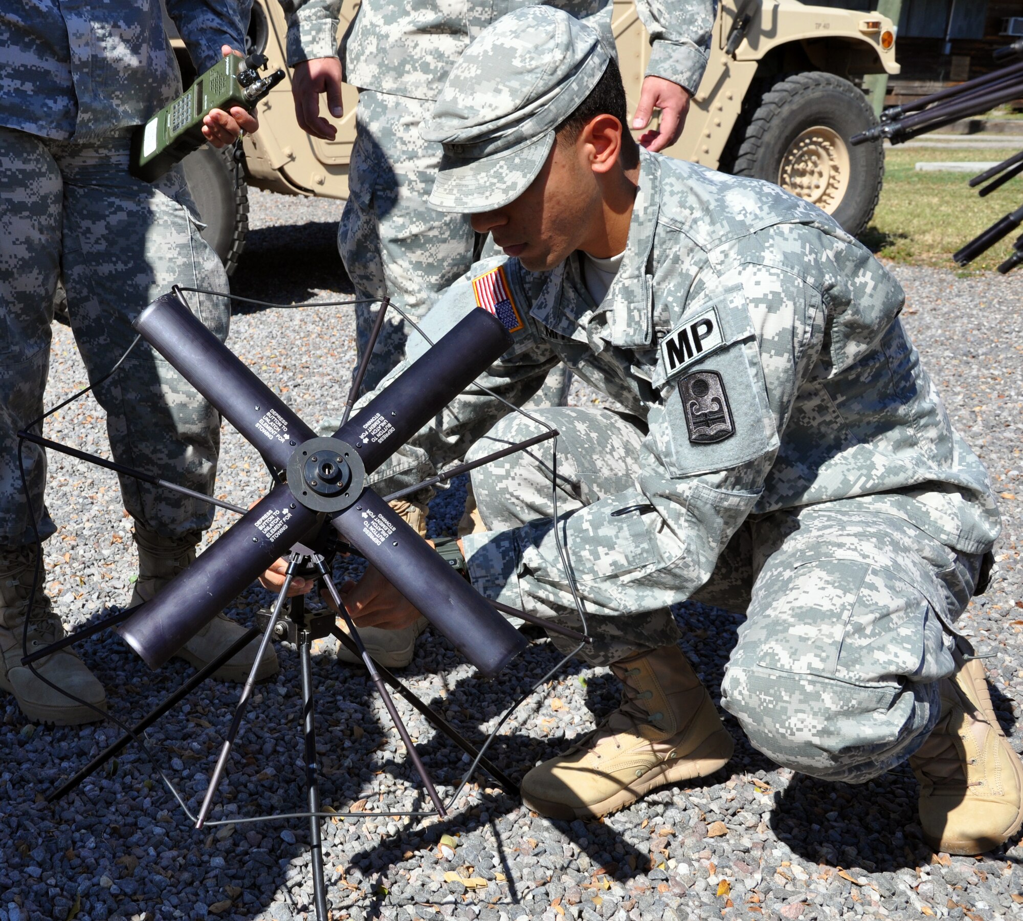 U.S. Army Spc. Luis Mitchell practices setting up a satellite communication antenna during a communication exercise (COMMEX) conducted by Joint Task Force-Bravo, Jan. 6, 2014. During the exercise, members of the task force were instructed on the operation of several types of communication equipment, and practiced using the equipment so they will be prepared to use it in a real-world scenario. (U.S. Air Force photo by Capt. Zach Anderson)