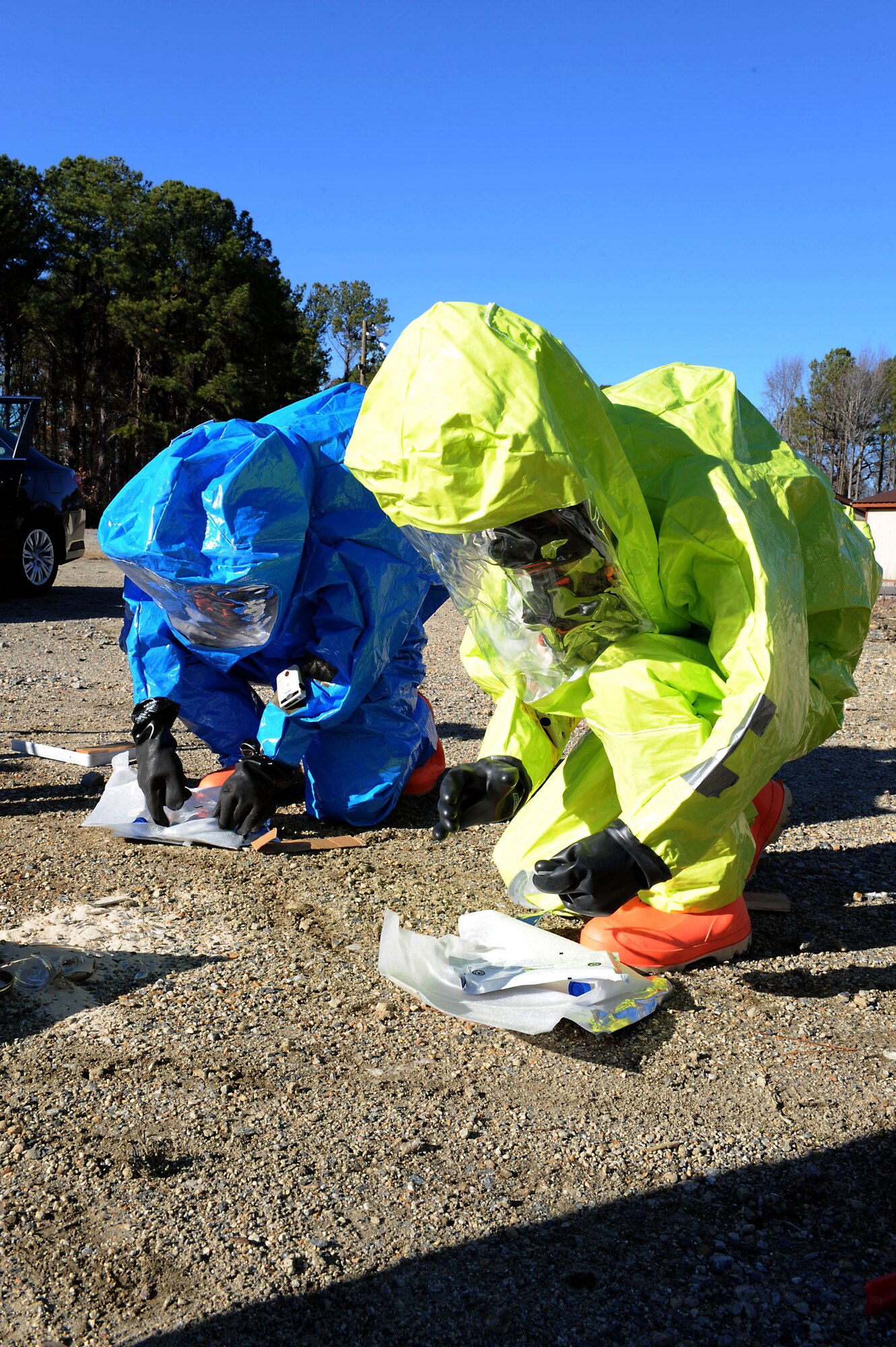 U.S. Air Force Airman 1st Class Zachary Day, 633rd Civil Engineer Squadron emergency manager, and Senior Airman Felicia Still, 633rd Aerospace Medical Squadron bioenvironmental engineering technician, test for explosive-borne contamination during a hazardous material exercise at Langley Air Force Base, Va., Dec. 18, 2013. The exercise examined how emergency management and bioenvironmental engineering personnel work together during a HAZMAT crisis. (U.S. Air Force photo by Senior Airman Brittany Paerschke-O’Brien/Released)