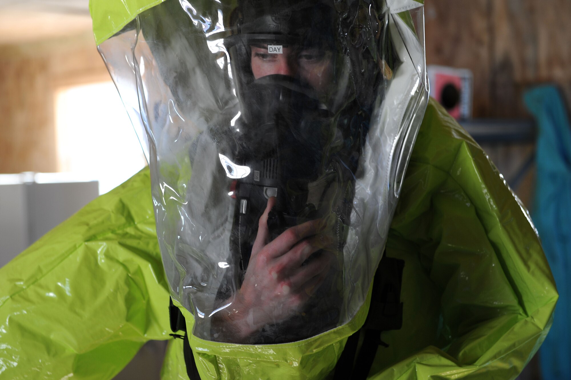 U.S. Air Force Airman 1st Class Zachary Day, 633rd Civil Engineer Squadron emergency manager, communicates via handheld radio during a hazardous material exercise at Langley Air Force Base, Va., Dec. 18, 2013. The scenarios allowed emergency management and law enforcement personnel to work together and improve crisis management skills. (U.S. Air Force photo by Senior Airman Brittany Paerschke-O’Brien/Released)