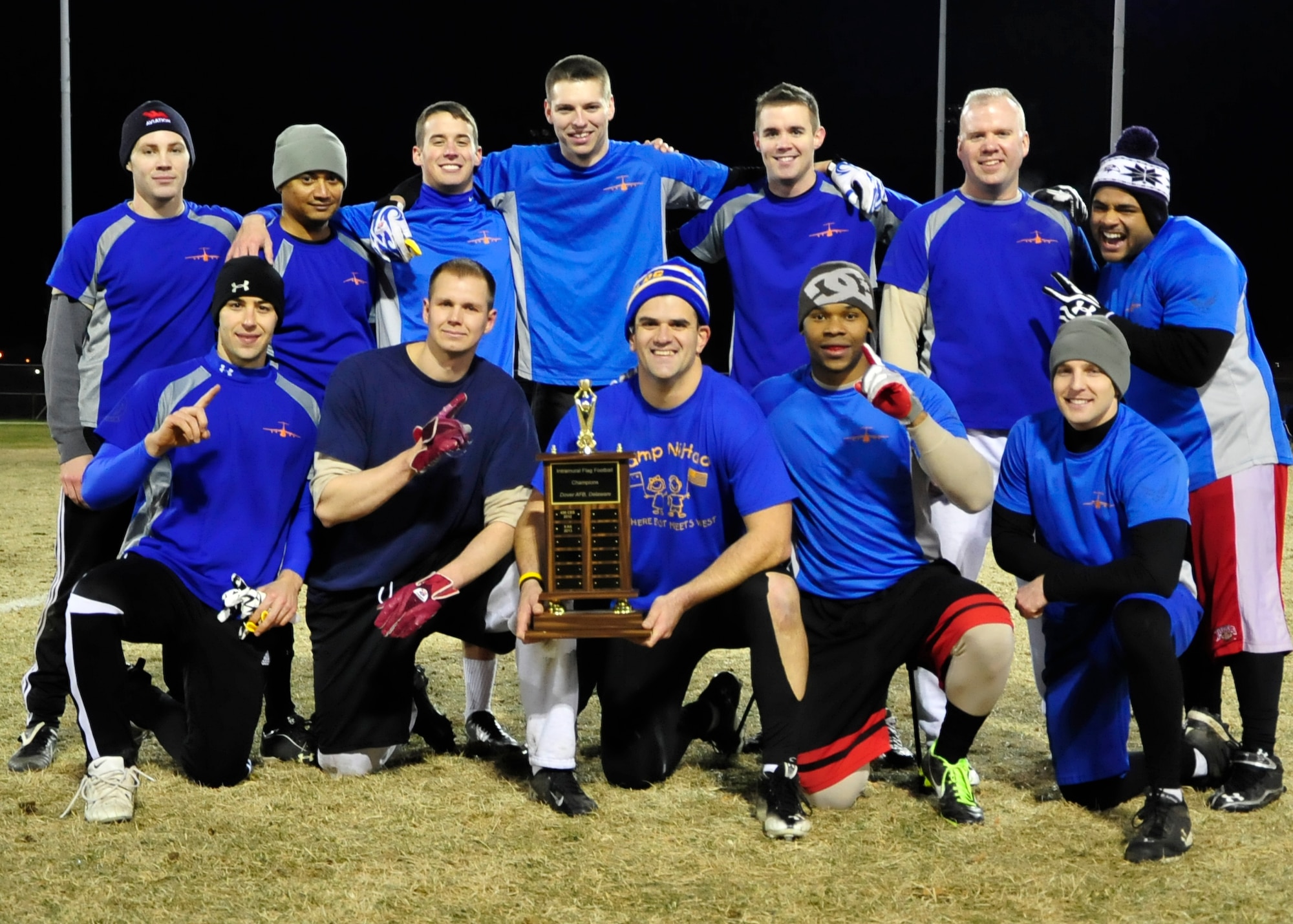 The 9th Airlift Squadron poses with their flag football championship trophy Dec. 18, 2013, at Dover Air Force Base, Del. The 9th AS defeated the 436th Force Support Squadron 28-20 to win their first flag football championship. (U.S. Air Force photo/Airman 1st Class William Johnson)