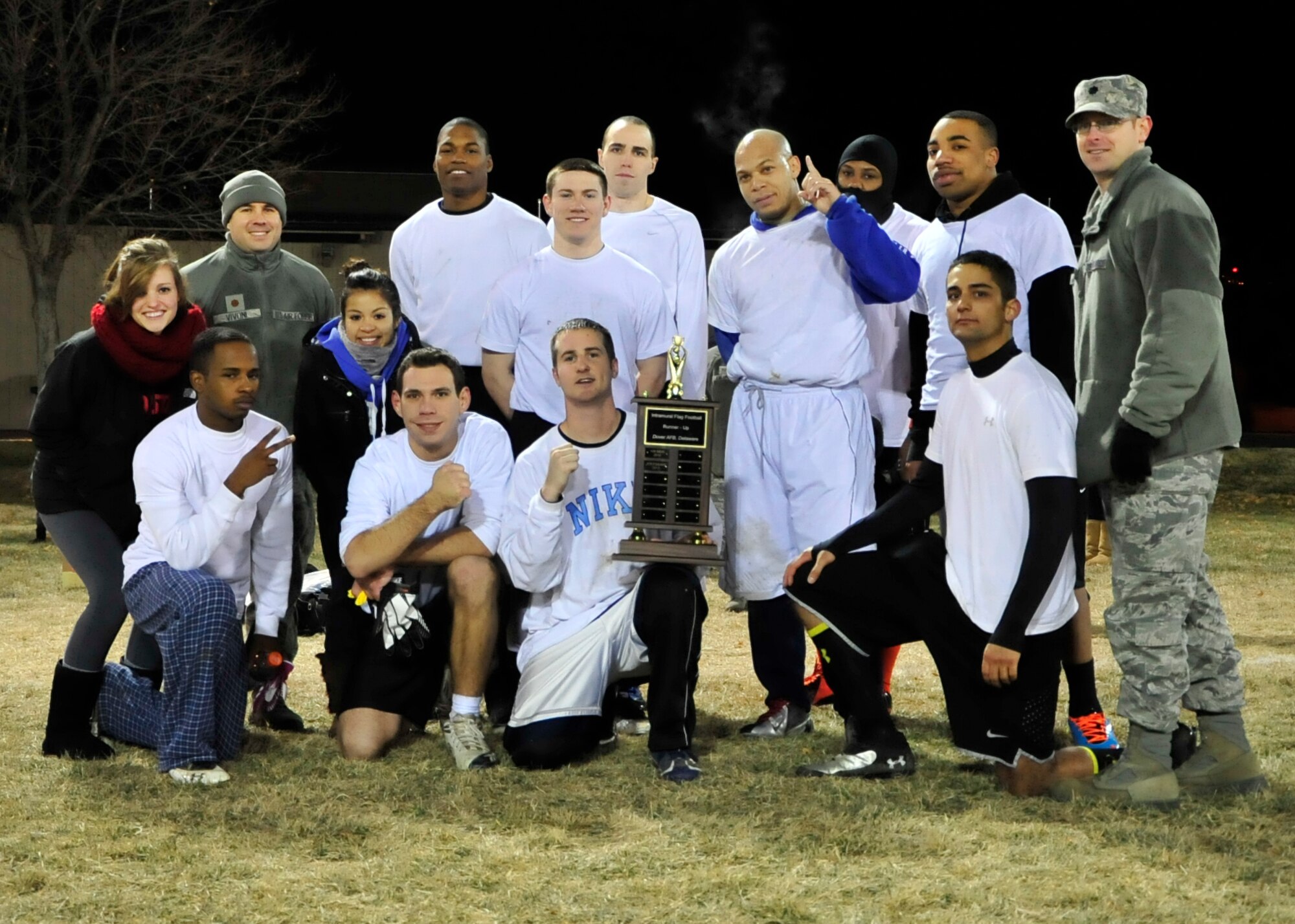 The 436th Force Support Squadron/Comptroller squadron team poses with their second place trophy for flag football Dec. 18, 2013, at Dover Air Force Base, Del. The trophy was presented by Lt. Col. Matthew Orlowsky, 436th FSS commander. (U.S. Air Force photo/Airman 1st Class William Johnson)