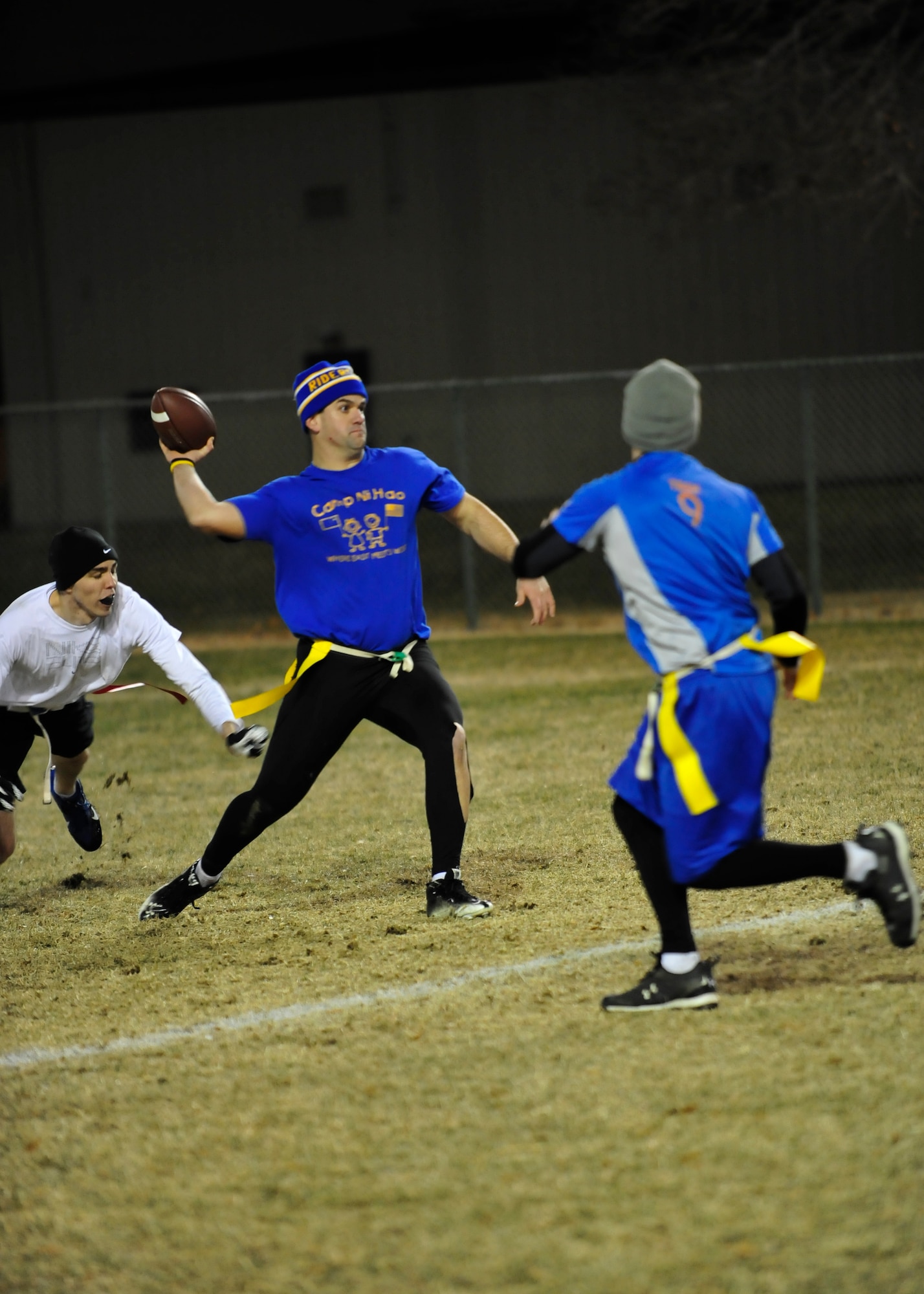 Cid Fernandez, 9th Airlift Squadron quarterback, throws a pass during the flag football championship game Dec. 18, 2013, at Dover Air Force Base, Del. Fernandez threw four touchdown passes to lead his team to victory against the 436th Force Support Squadron 28-20. (U.S. Air Force photo/Airman 1st Class William Johnson)