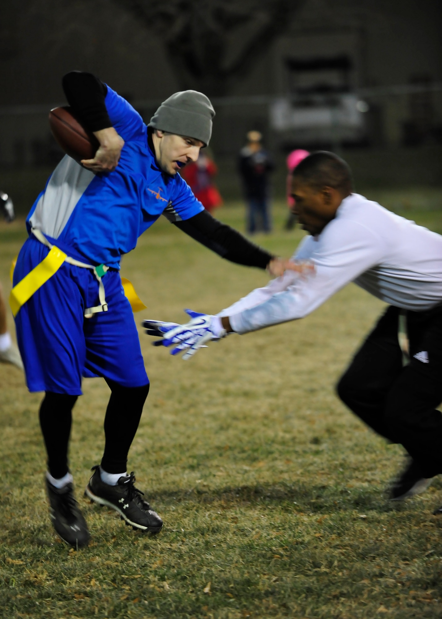 Adam Ferkovich, 9th Airlift Squadron receiver, avoids a tackle during the flag football championship game Dec. 19, 2013 at Dover Air Force Base, Del. The 9th AS defeated the 436th Force Support Squadron/Comptroller Squadron 28-20 for their first flag football championship. (U.S. Air Force photo/Airman 1st Class William Johnson)