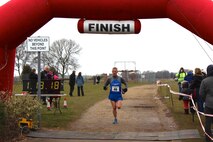 U.S. Air Force Lt. Col. Christopher Bennett, Headquarters Air Force Reservist Directorate, Air Staff, Pentagon, chief of airlift and tanker requirements, prepares to cross the finish line at the Sleaford half-marathon Feb. 24, 2013, which started and finished at RAF Cranwell, Lincolnshire, England. Bennett recently completed his goal of running "20 13s" in 2013 – 20 half-marathons, the majority of which he ran while stationed at RAF Mildenhall in England. (Courtesy photo by Molly Bennett/Released)
