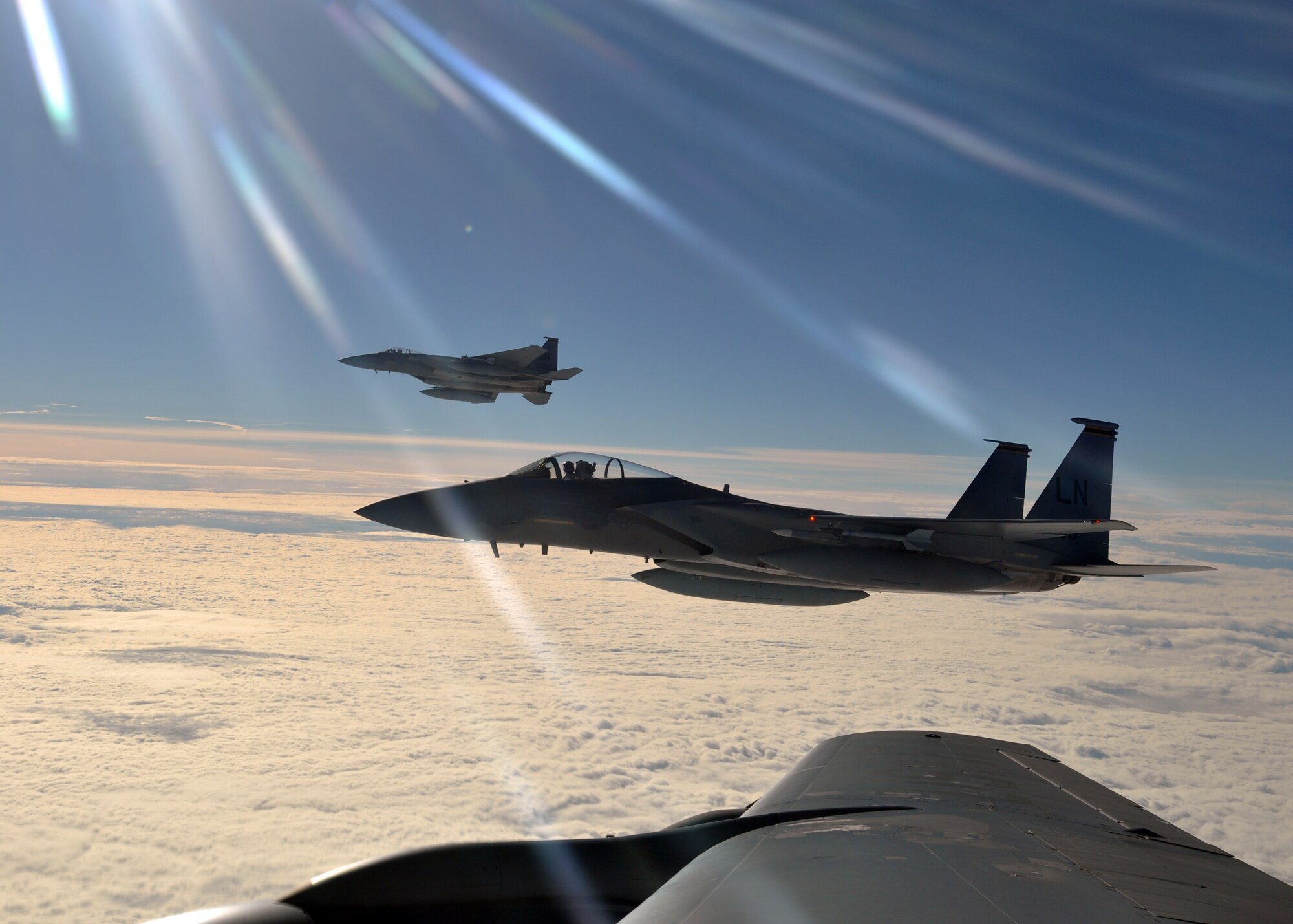Two F-15C Eagles from the 48th Fighter Wing prepare to return to their simulated air combat portion of the Arctic Challenge exercise after refueling from a 100th Air Refueling Wing KC-135 Stratotanker Sept. 20, 2013, over Norway. The exercise enabled increased interoperability between NATO, the U.S., the United Kingdom and members of the Nordic Defense Cooperation. (U.S. Air Force photo by 1st Lt. Christopher Mesnard/Released)

