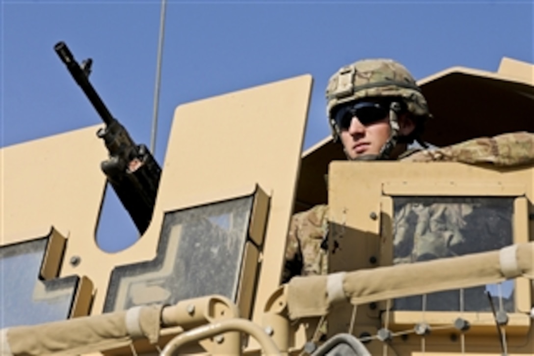 U.S. Army Spc. Kory Klinger provides security around the site where soldiers from his company were training Afghans soldiers to handle heavy equipment on Forward Operating Base Gamberi, Afghanistan, Jan. 5, 2014. The Afghan soldiers were learning new skills to better assist the Afghan army as it prepares for upcoming Afghan presidential elections. 
