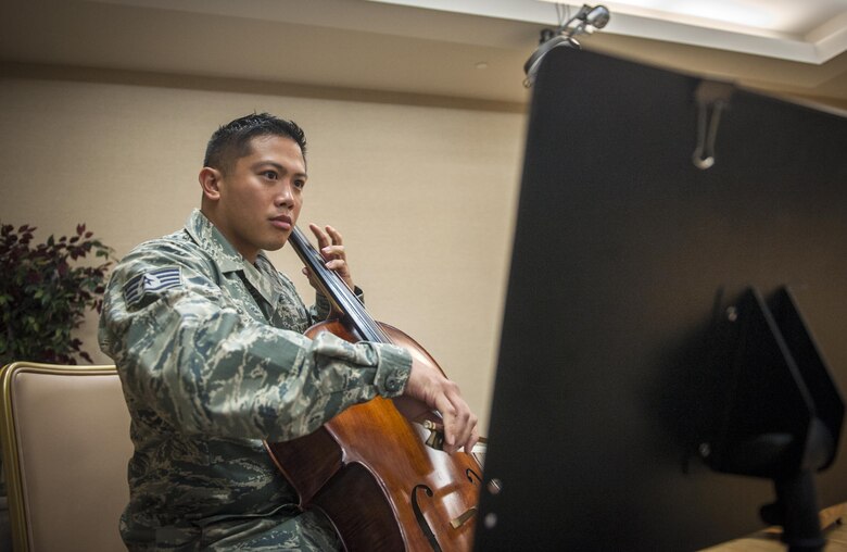 Staff Sgt. Joey Lee plays the national anthem on his cello Sept. 6, 2013, at Moody Air Force Base, Ga. He started playing the cello when he was 9 years old. Lee is a 23rd Aerospace Medicine Squadron public health technician. (U.S. Air Force photo/Senior Airman Jarrod Grammel) 