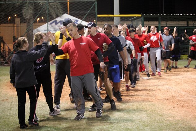 U.S. Marine Corps Forces Central Command Forward Legends (red) congratulate their rivals the NSA Bahrain Base Team “Stay Classy,” after a double extra inning softball thriller in which “Stay Classy” won 17-16.