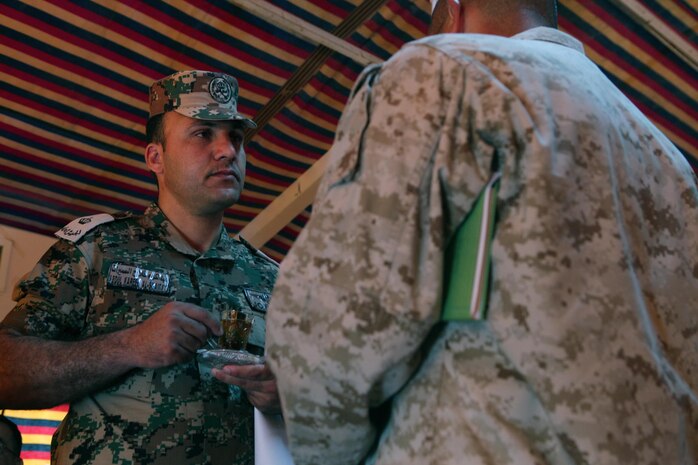 Maj. Abdul Kareem Al-Smairat, the supply and equipment officer for the 91st Armored Brigade, Royal Jordanian Armed Forces, listens as U.S. Marine Maj. Johnny Garza, a San Benito, Texas, native, and the logistics operations officer with U.S. Marine Corps Forces Central Command (Forward), discusses planned events of Exercise Eager Lion 2013 during a meet and greet at Camp Titin, Jordan, June 9, 2013.